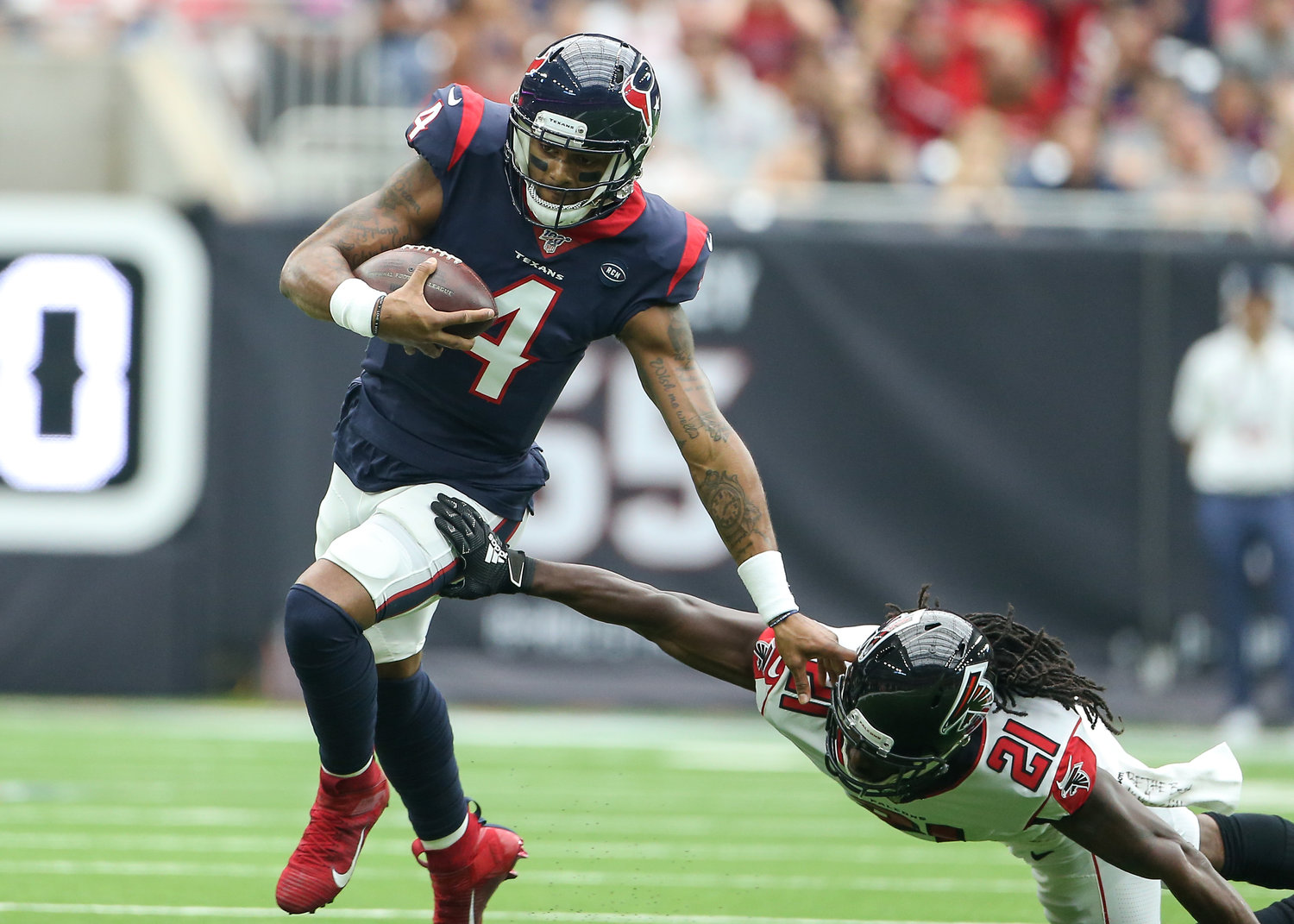 Houston Texans quarterback Deshaun Watson (4) eludes Atlanta Falcons cornerback Desmond Trufant (21) on a scramble during an NFL game between the Houston Texans and the Atlanta Falcons at NRG Stadium in Houston, Texas, on Oct. 6, 2019.