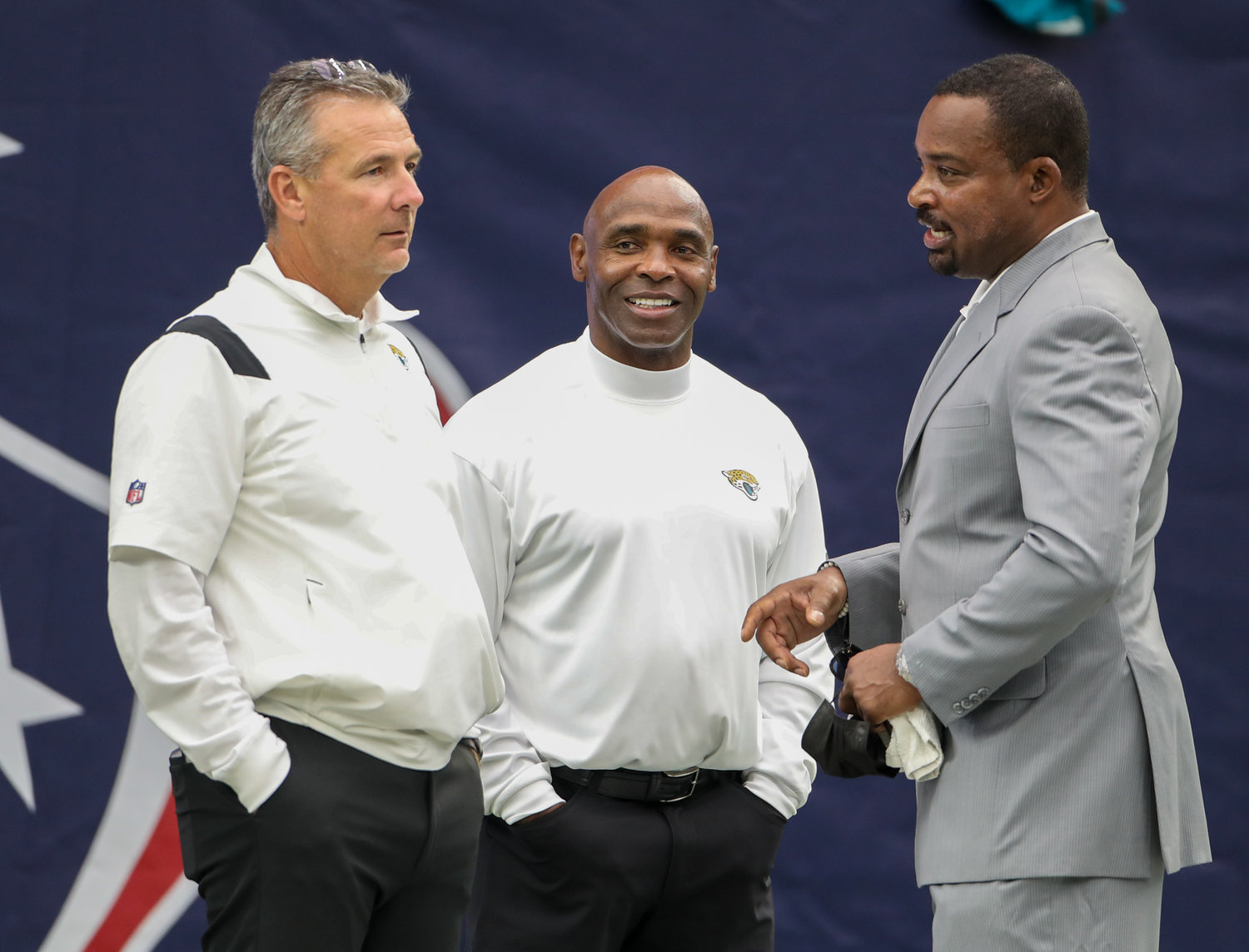 Jacksonville Jaguars head coach Urban Meyer (left) and assistant head coach Charlie Strong (center) before the start of an NFL game between the Houston Texans and the Jacksonville Jaguars on September 12, 2021 in Houston, Texas.