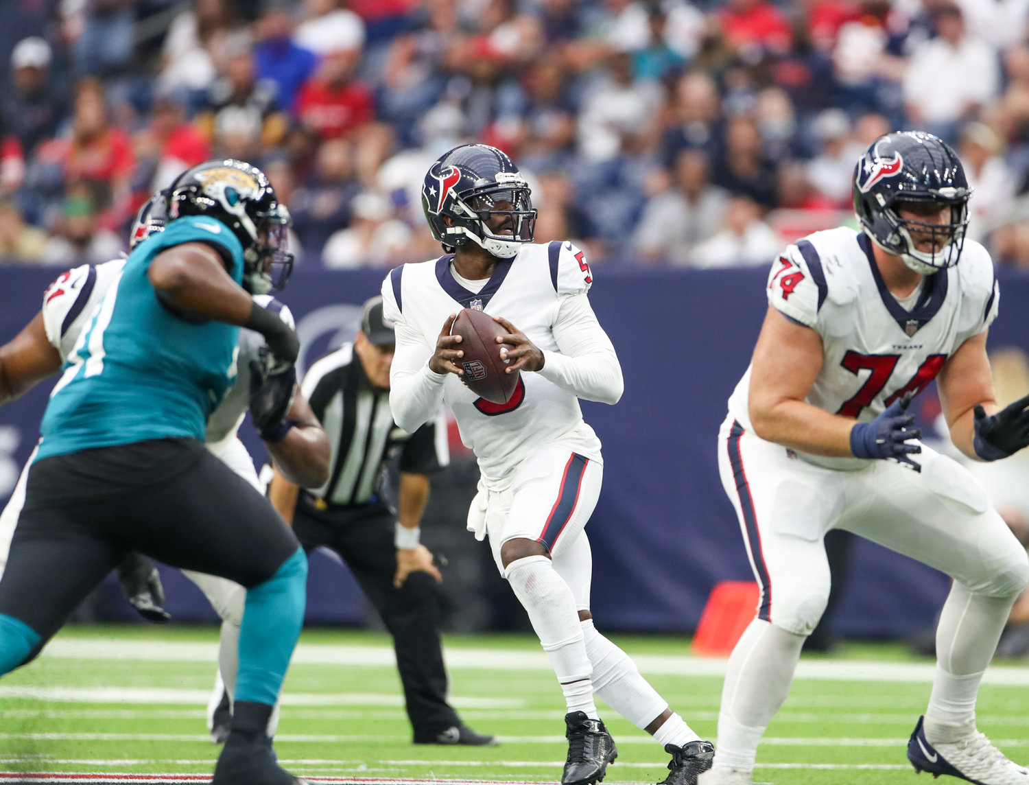 Houston Texans quarterback Tyrod Taylor (5) drops back to pass during the first half of an NFL game between the Houston Texans and the Jacksonville Jaguars on September 12, 2021 in Houston, Texas.