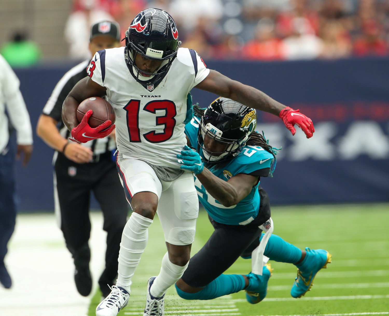 Houston Texans wide receiver Brandin Cooks (13) carries the ball after a reception during the first half of an NFL game between the Houston Texans and the Jacksonville Jaguars on September 12, 2021 in Houston, Texas.