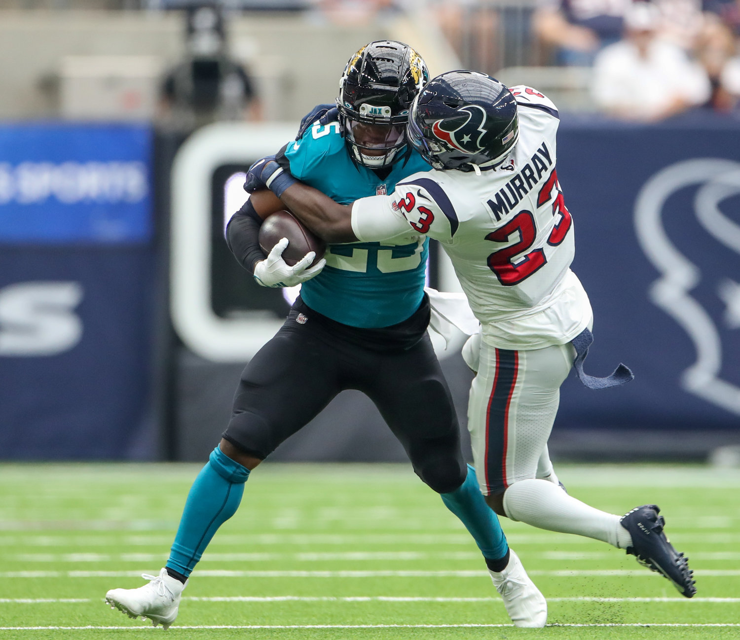 Houston Texans strong safety Eric Murray (23) brings down Jacksonville Jaguars running back James Robinson (25) during the first half of an NFL game between the Houston Texans and the Jacksonville Jaguars on September 12, 2021 in Houston, Texas.