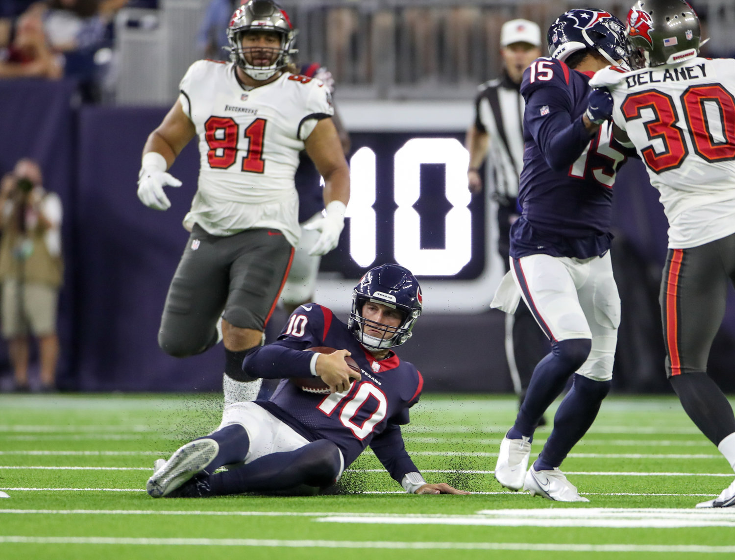 Houston Texans quarterback Davis Mills (10) slides after a 15-yard scramble during an NFL preseason game between the Houston Texans and the Tampa Bay Buccaneers on August 28, 2021 in Houston, Texas.