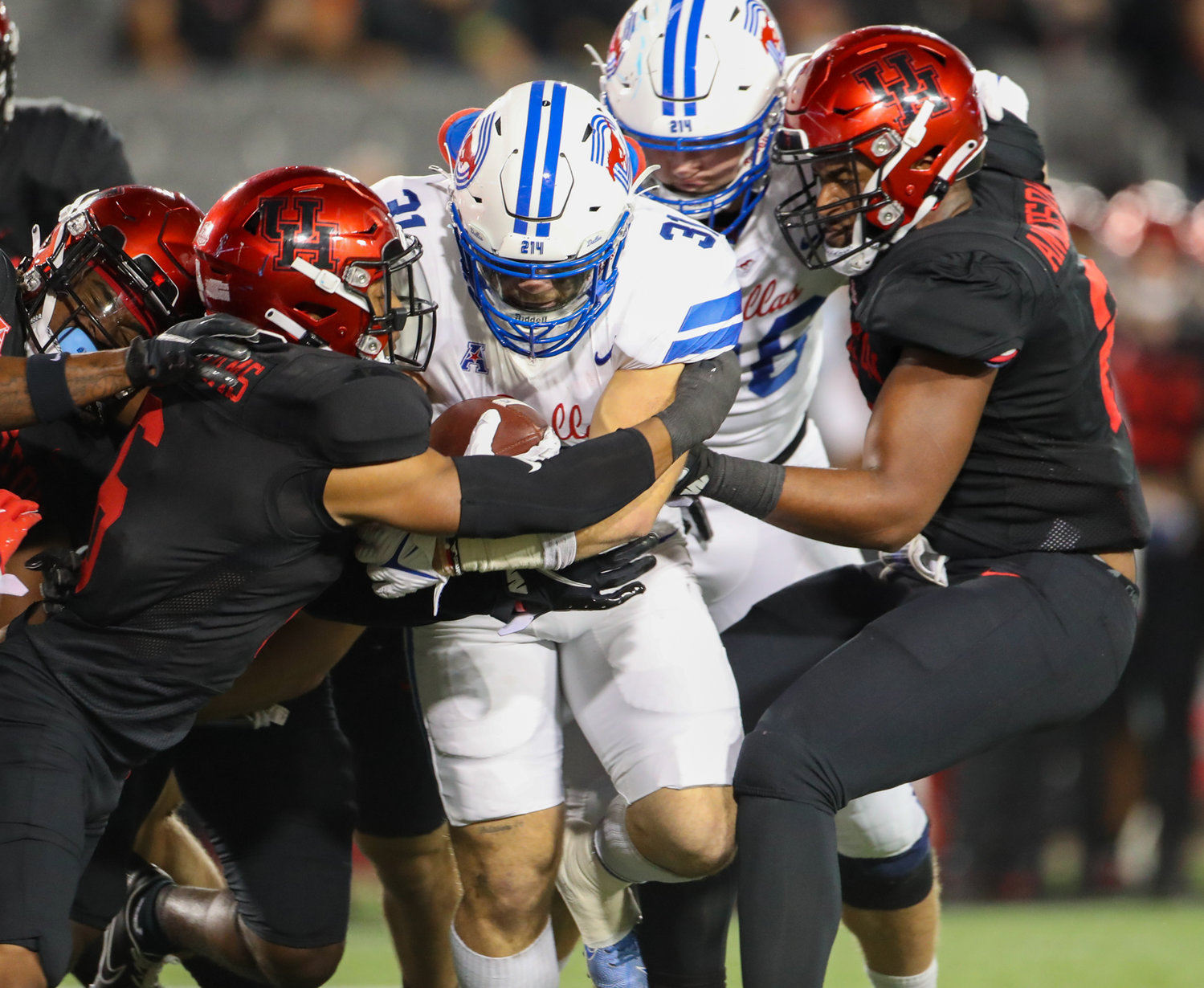 SMU Mustangs running back Tyler Lavine (31) is tackled on a carry during an NCAA football game between Houston and SMU on October 30, 2021 in Houston, Texas.