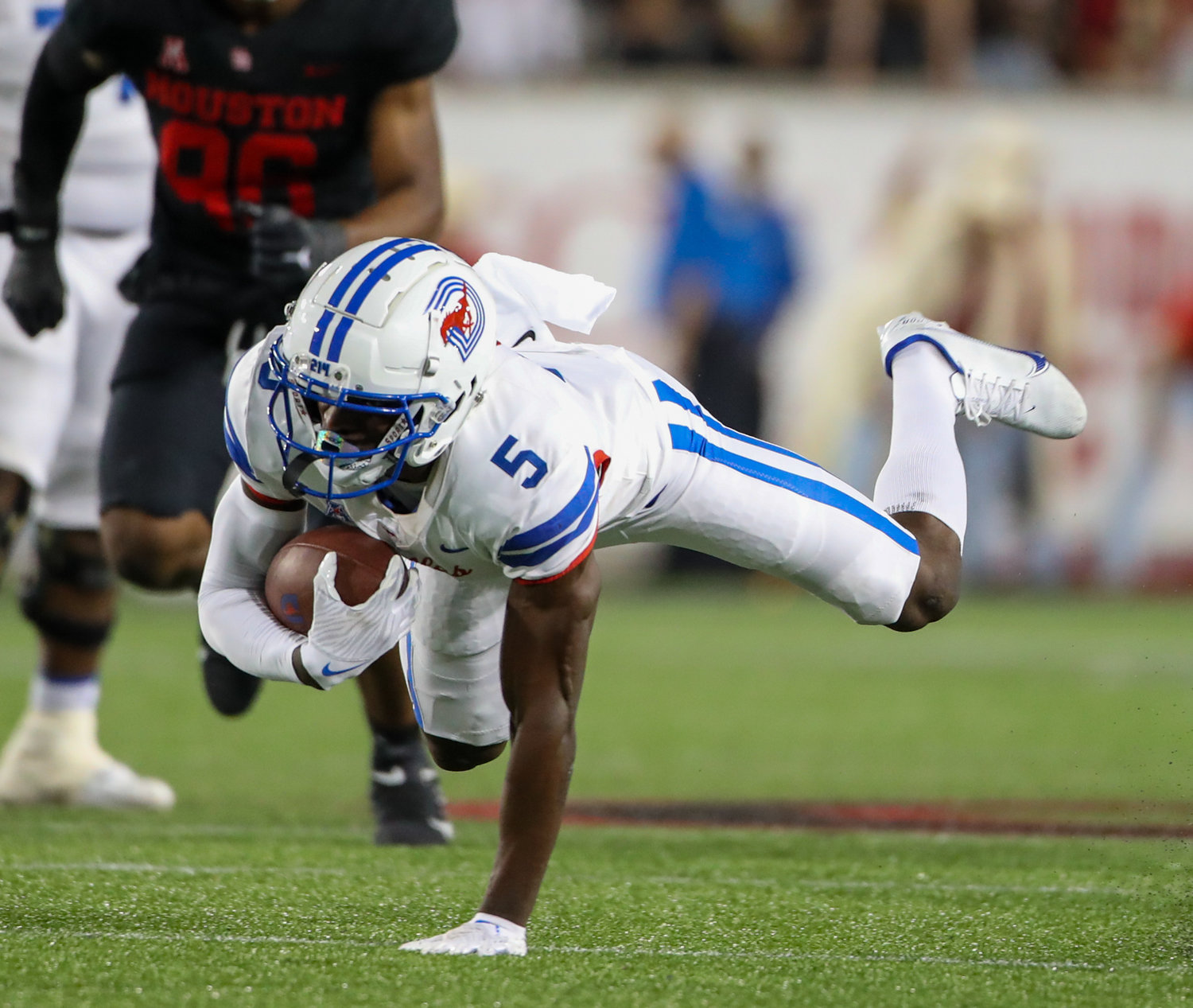 SMU Mustangs wide receiver Danny Gray (5) goes down after a reception during an NCAA football game between Houston and SMU on October 30, 2021 in Houston, Texas.