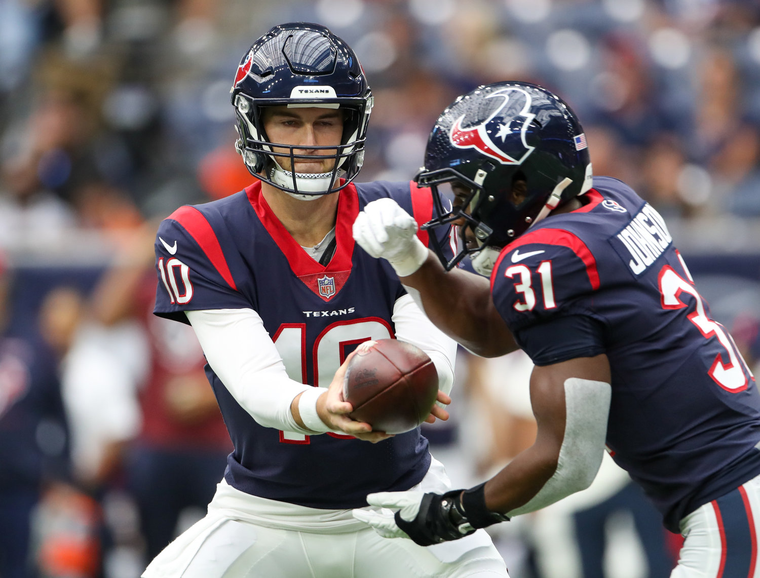 Houston Texans quarterback Davis Mills (10) hands the ball off to running back David Johnson (31) during an NFL game between Houston and the Los Angeles Rams on October 31, 2021 in Houston, Texas.
