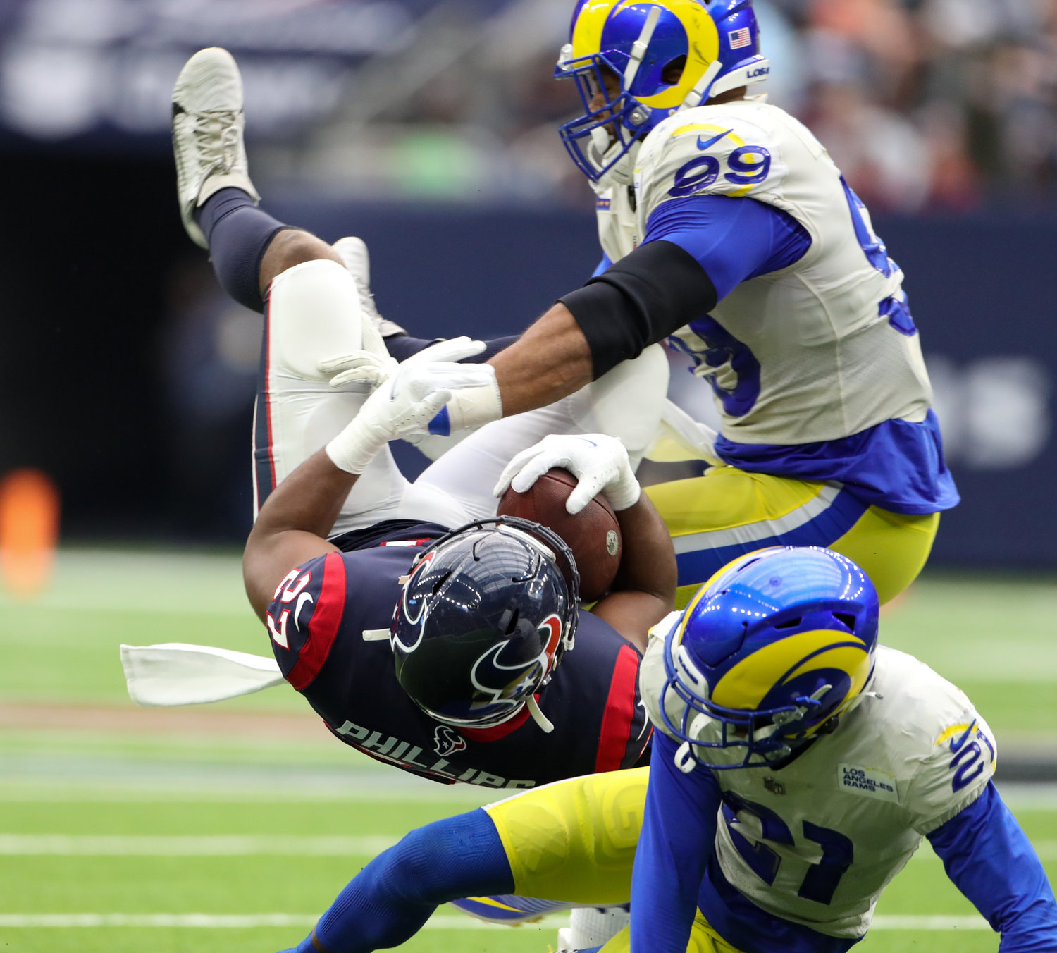 Los Angeles Rams defensive tackle Aaron Donald (99) and cornerback Dont'e Deayon (21) bring down Houston Texans running back Scottie Phillips (27) during an NFL game between Houston and the Los Angeles Rams on October 31, 2021 in Houston, Texas.
