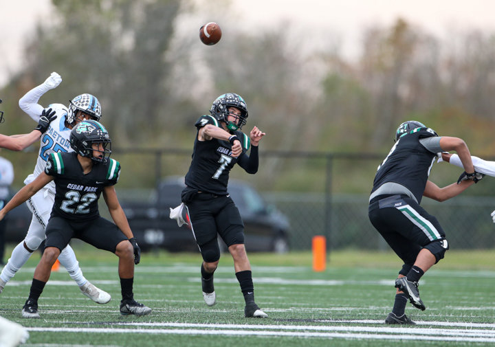Cedar Park Timberwolves senior quarterback Joshua Pell (7) throws the ball on a pass that was intercepted by Paetow Panthers senior defensive back Michael Jordan (12) during a high school football playoff game between Cedar Park and Paetow on November 26, 2021 in Waller, Texas.