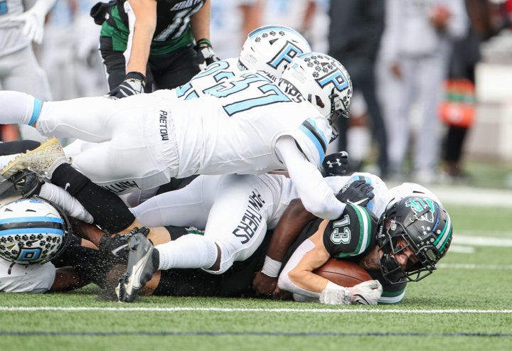 A group of Paetow Panthers tackle Cedar Park Timberwolves senior wide receiver Houston Molinaro (13) during a high school football playoff game between Cedar Park and Paetow on November 26, 2021 in Waller, Texas.