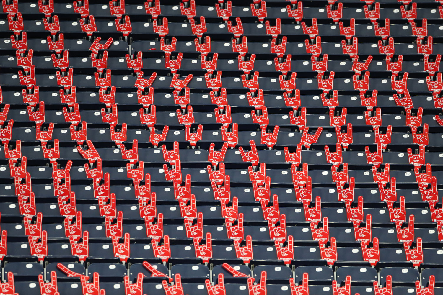 A section of empty seats with foam hands for fans before the start of an NFL game between the Houston Texans and the New York Jets on November 28, 2021 in Houston, Texas.