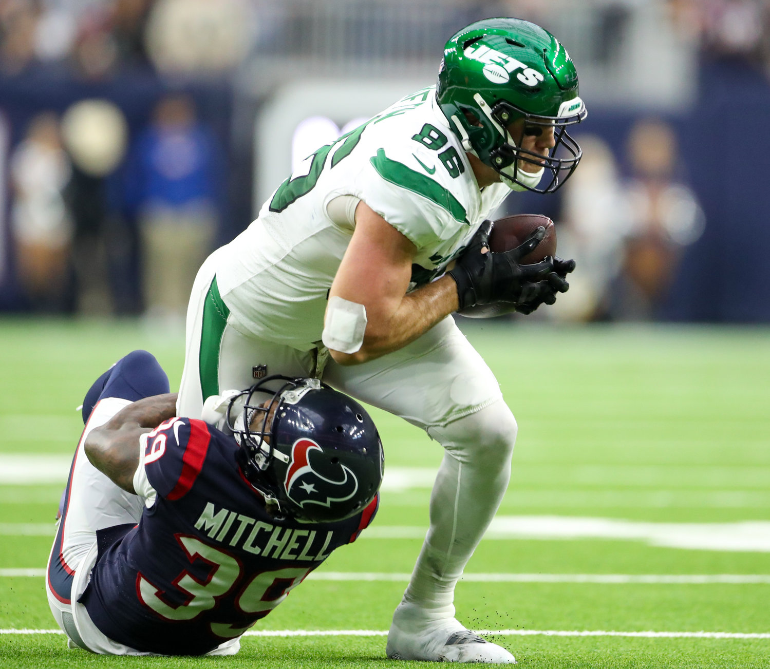 New York Jets tight end Ryan Griffin (86) drags Houston Texans cornerback Terrance Mitchell (39) for additional yards after a catch during an NFL game between the Houston Texans and the New York Jets on November 28, 2021 in Houston, Texas. The Jets won, 21-14