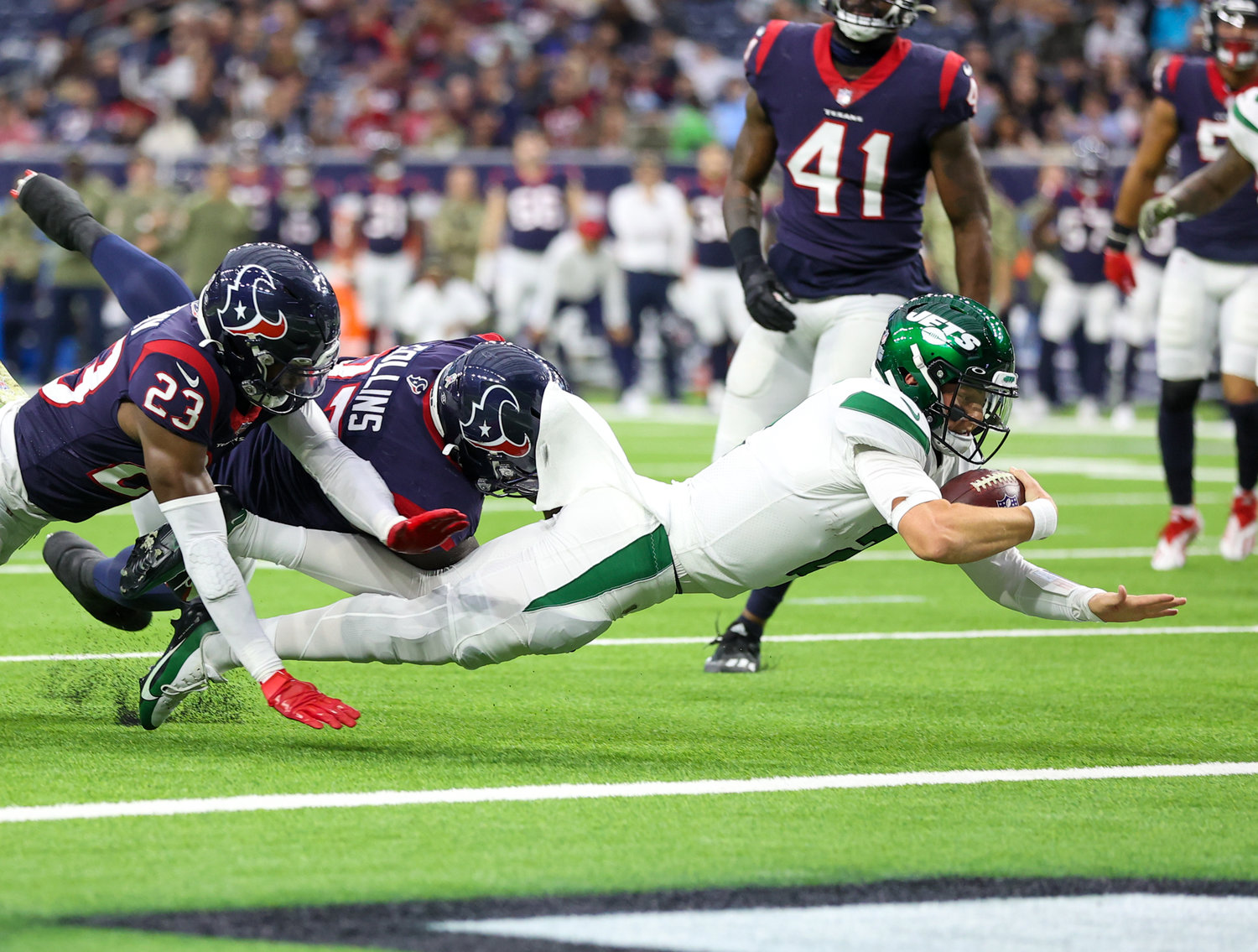 New York Jets quarterback Zach Wilson (2) dives into the end zone for a touchdown on a 4-yard carry during the third quarter of an NFL game between the Houston Texans and the New York Jets on November 28, 2021 in Houston, Texas. The Jets won, 21-14