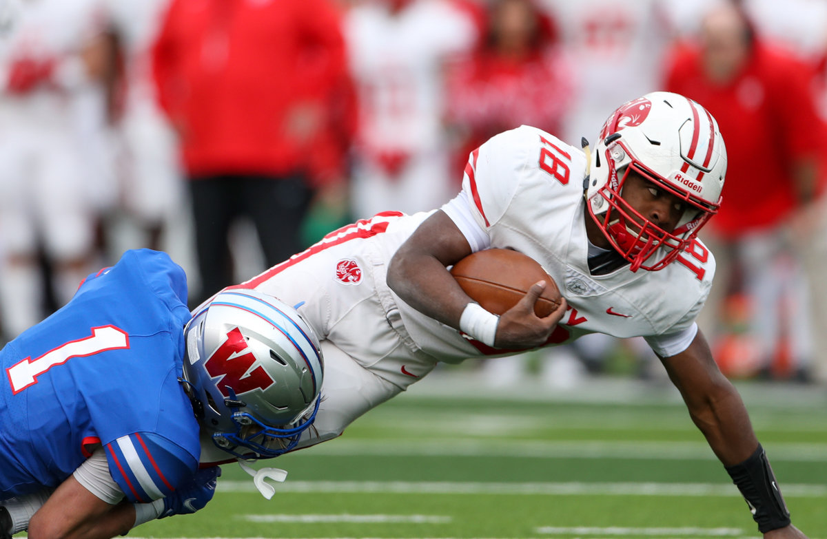 Katy Tigers running back Dallas Glass (18) dives forward for additional yardage during the Class 6A Division II state semifinal  game between Katy and Westlake on December 11, 2021 in Waco, Texas.