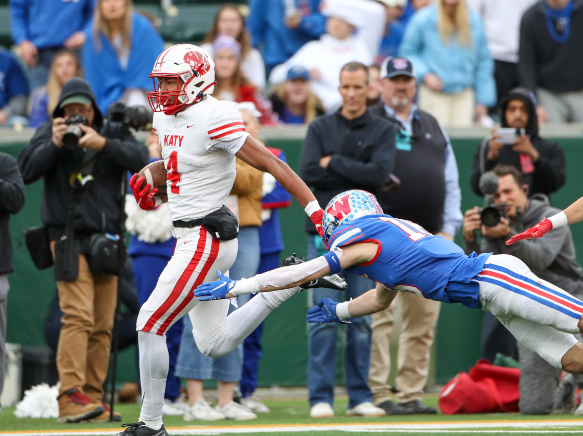 Katy Tigers wide receiver Nic Anderson (4) runs past Westlake Chaparrals defensive back Will Courtney (16) on a catch-and-run touchdown during the Class 6A Division II state semifinal  game between Katy and Westlake on December 11, 2021 in Waco, Texas.