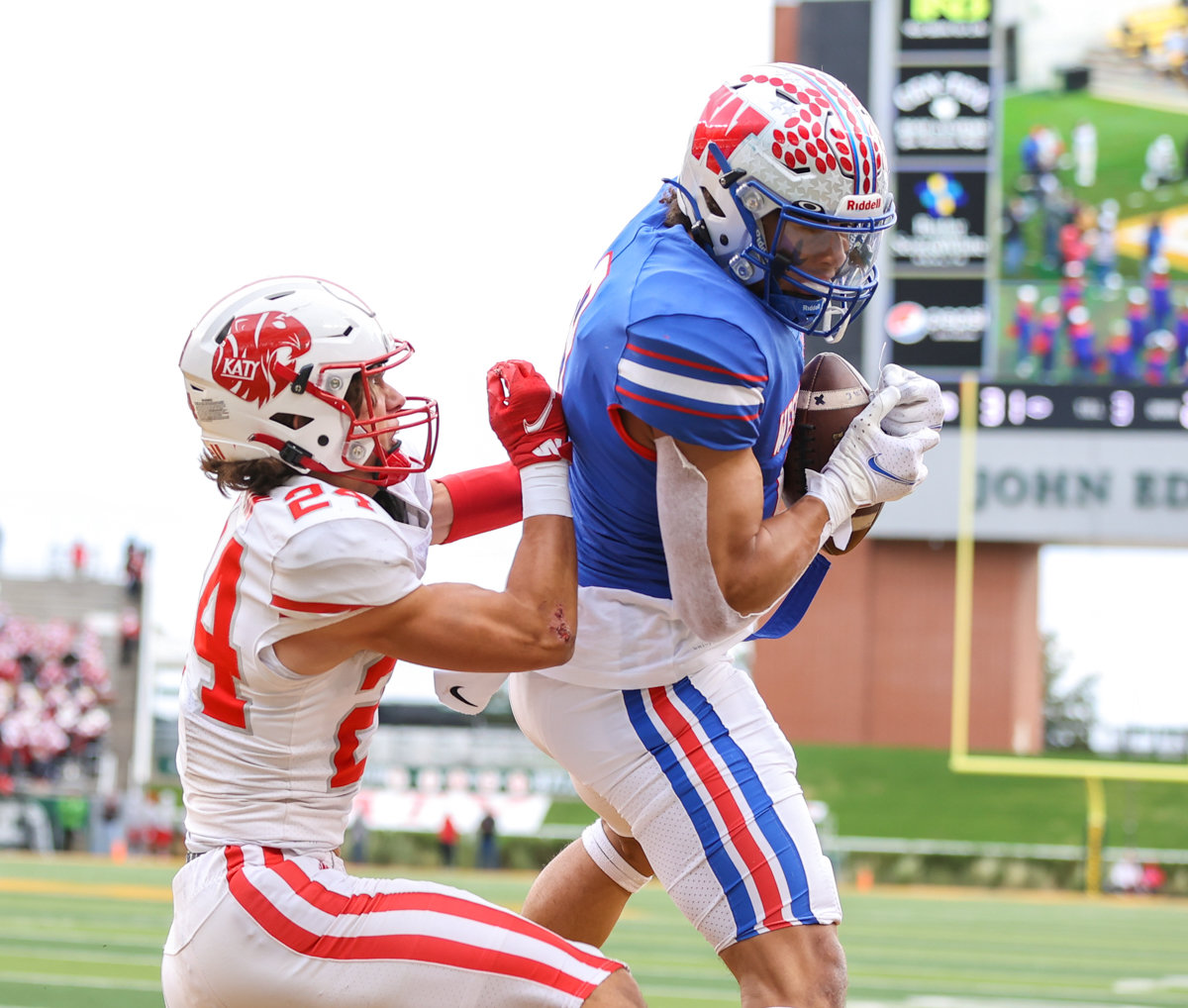 Westlake Chaparrals wide receiver Jaden Greathouse (9) brings in a touchdown pass over Katy Tigers defensive back Hamilton McMartin (24) during the Class 6A Division II state semifinal on December 11, 2021 in Waco, Texas.