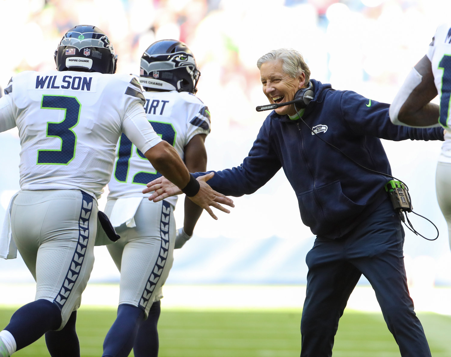 Seattle Seahawks head coach Pete Carroll congratulates quarterback Russell Wilson (3) after a touchdown during the first half of an NFL game between the Seahawks and the Texans on December 12, 2021 in Houston, Texas.