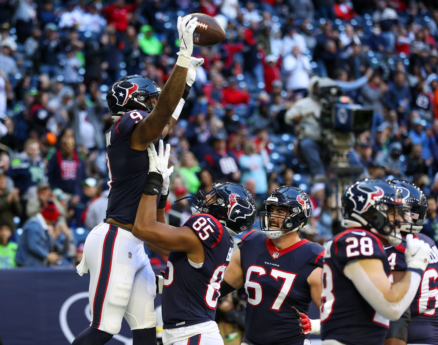 Teammates congratulate Houston Texans tight end Brevin Jordan (9) after a touchdown during the first half of an NFL game between the Seahawks and the Texans on December 12, 2021 in Houston, Texas.