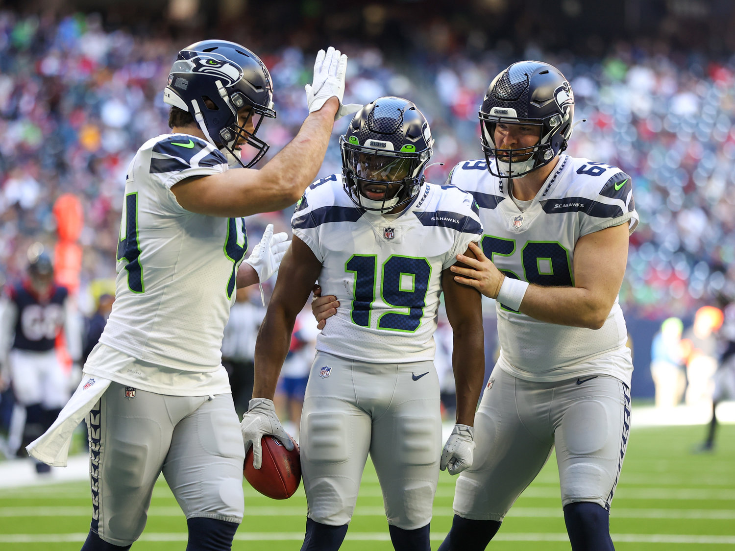 Teammates congratulate Seattle Seahawks wide receiver Penny Hart (19) after downing a punt at the 2-yard line during the first half of an NFL game between the Seahawks and the Texans on December 12, 2021 in Houston, Texas.