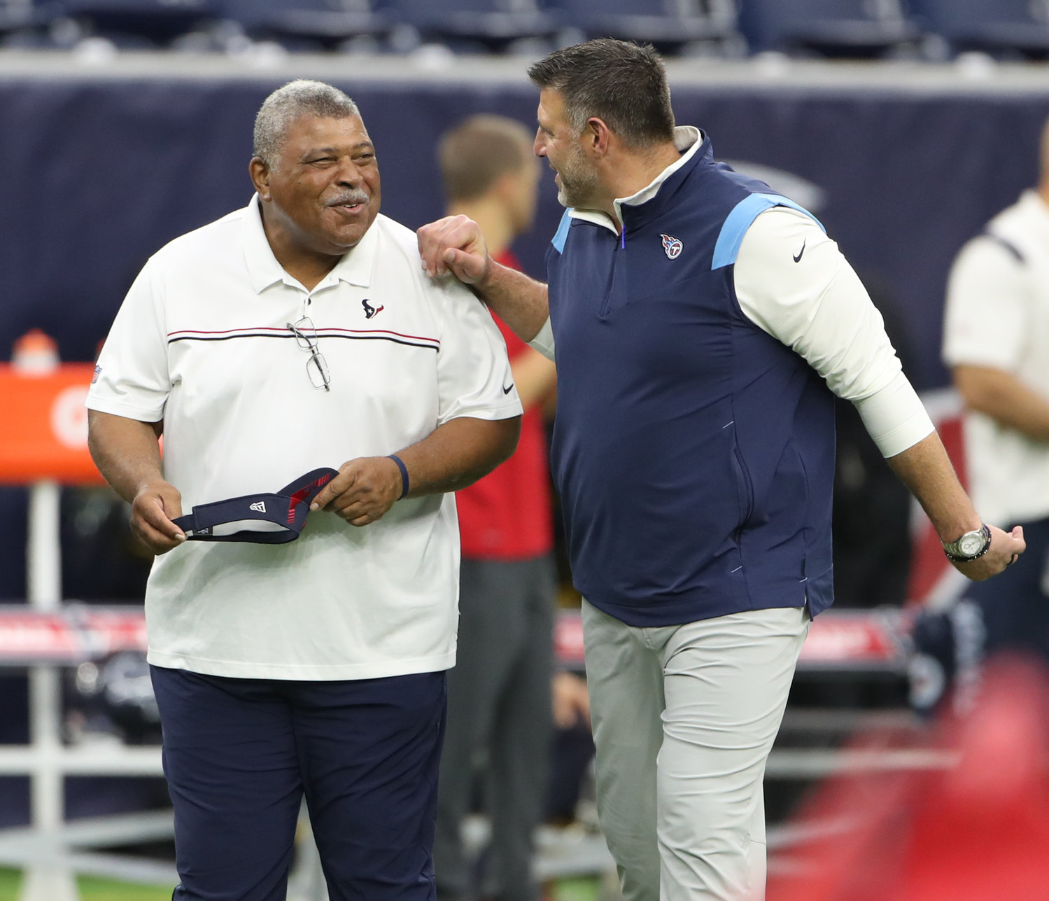 Houston Texans senior advisor for football operations Romeo Crennel talks with Tennessee Titans head coach Mike Vrabel before the start of an NFL game between the Texans and the Titans on Jan. 9, 2022 in Houston, Texas.