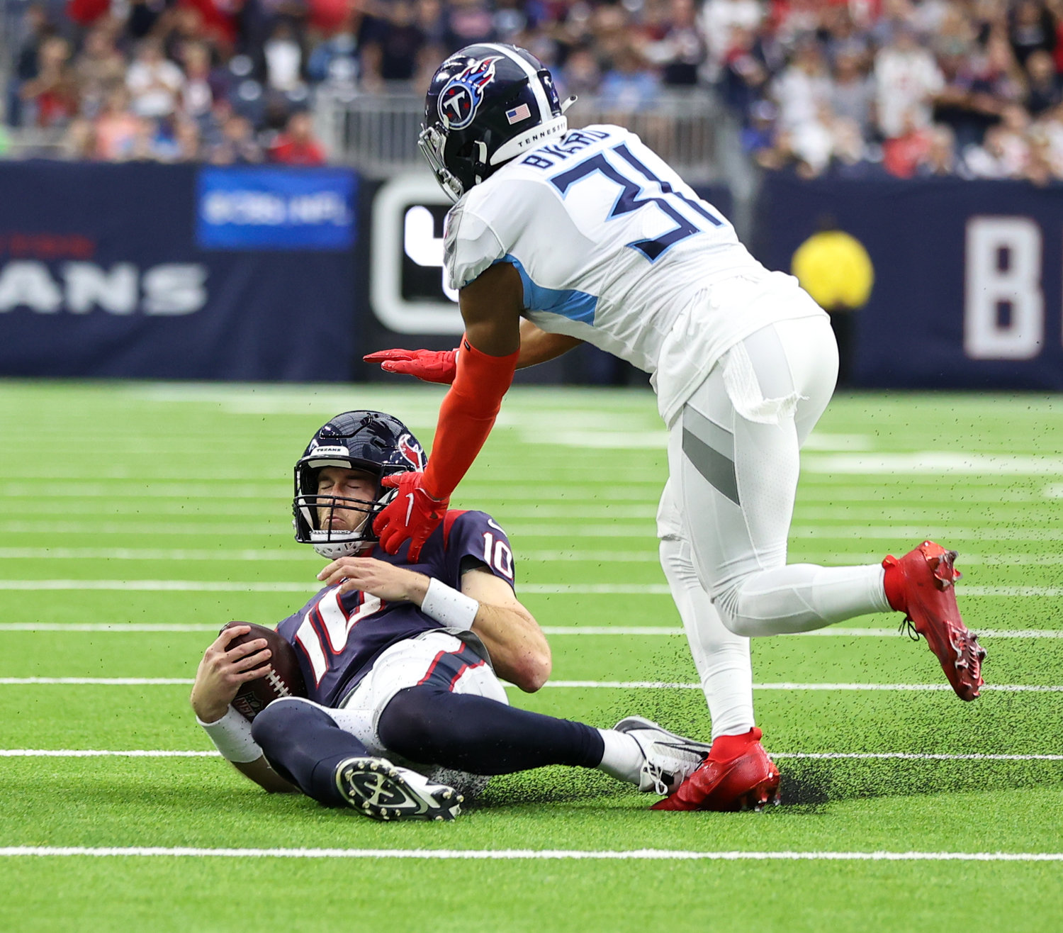 Houston Texans quarterback Davis Mills (10) slides down after gaining a first down during an NFL game between the Texans and the Titans on Jan. 9, 2022 in Houston, Texas. The Titans won, 28-25.