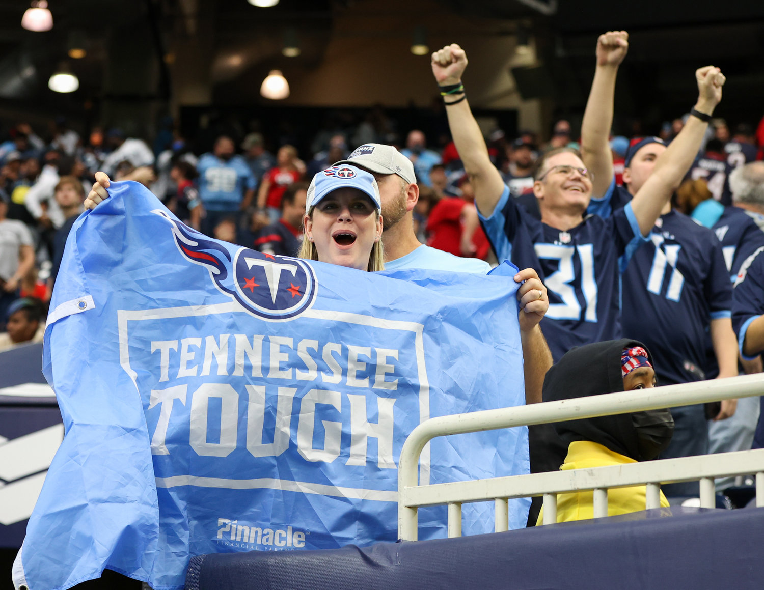 Tennessee Titans fans celebrate a 28-25 win over the Houston Texans, clinching home field advantage and a first-round bye in the playoffs, on Jan. 9, 2022 in Houston, Texas. The Titans won, 28-25.