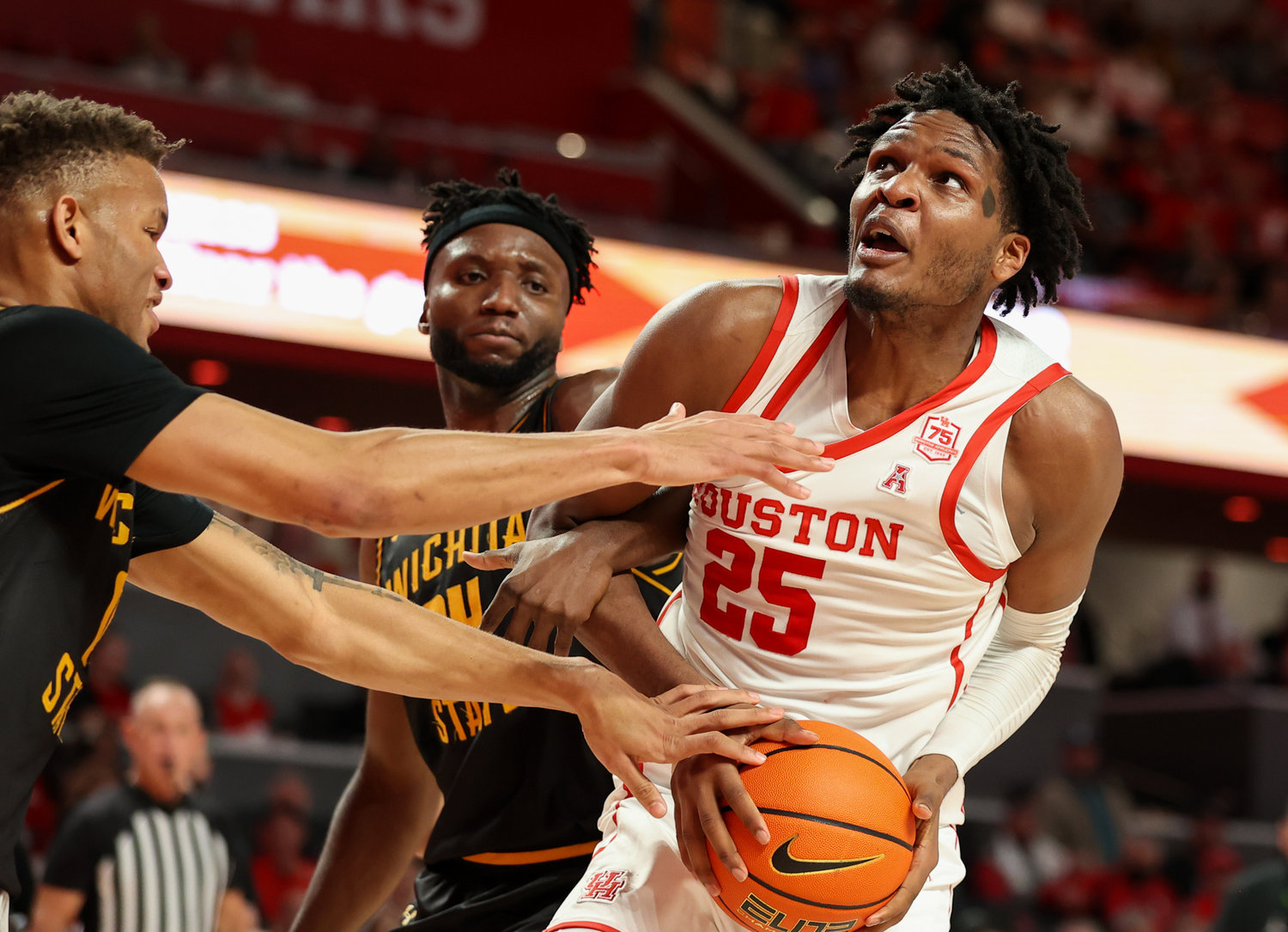 Houston Cougars center Josh Carlton (25) is fouled under the basket during an NCAA men’s basketball game between Houston and Wichita State on Jan. 8, 2022 in Houston, Texas.