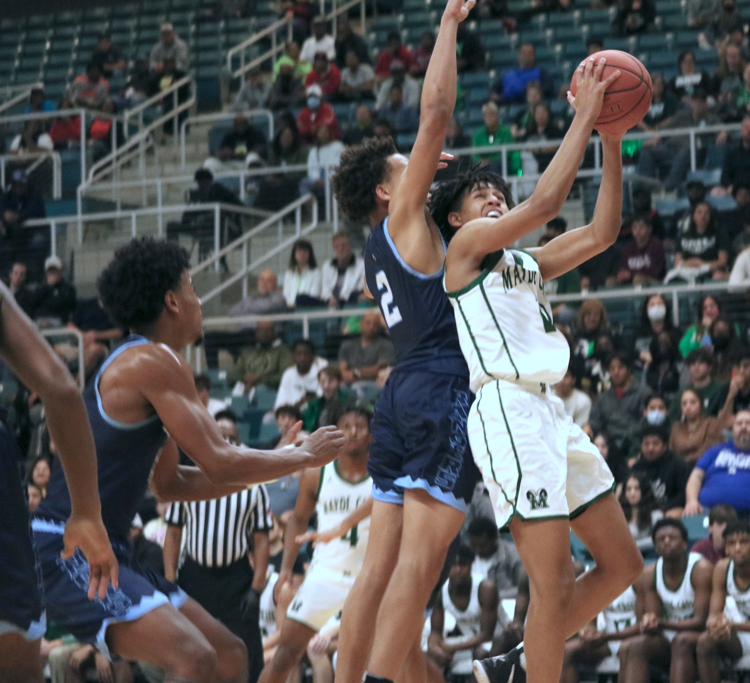 Larison LaMette fights through contact as he shoots a layup during Tuesday’s Class 6A regional quarterfinal between Mayde Creek and Fort Bend Clements at the Merrell Center.