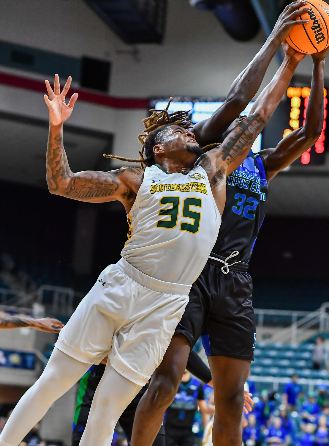 March 12,, 2022:  Southeastern Louisianas Gus Okafor #35 and A&M-Corpus Christis Stephen Faramade #32 battle for the rebound during the Southland Conference Basketball Championship game between A&M Corpus Christi vs Southeastern Louisiana. (Photo by Mark Goodman / Katy Times)