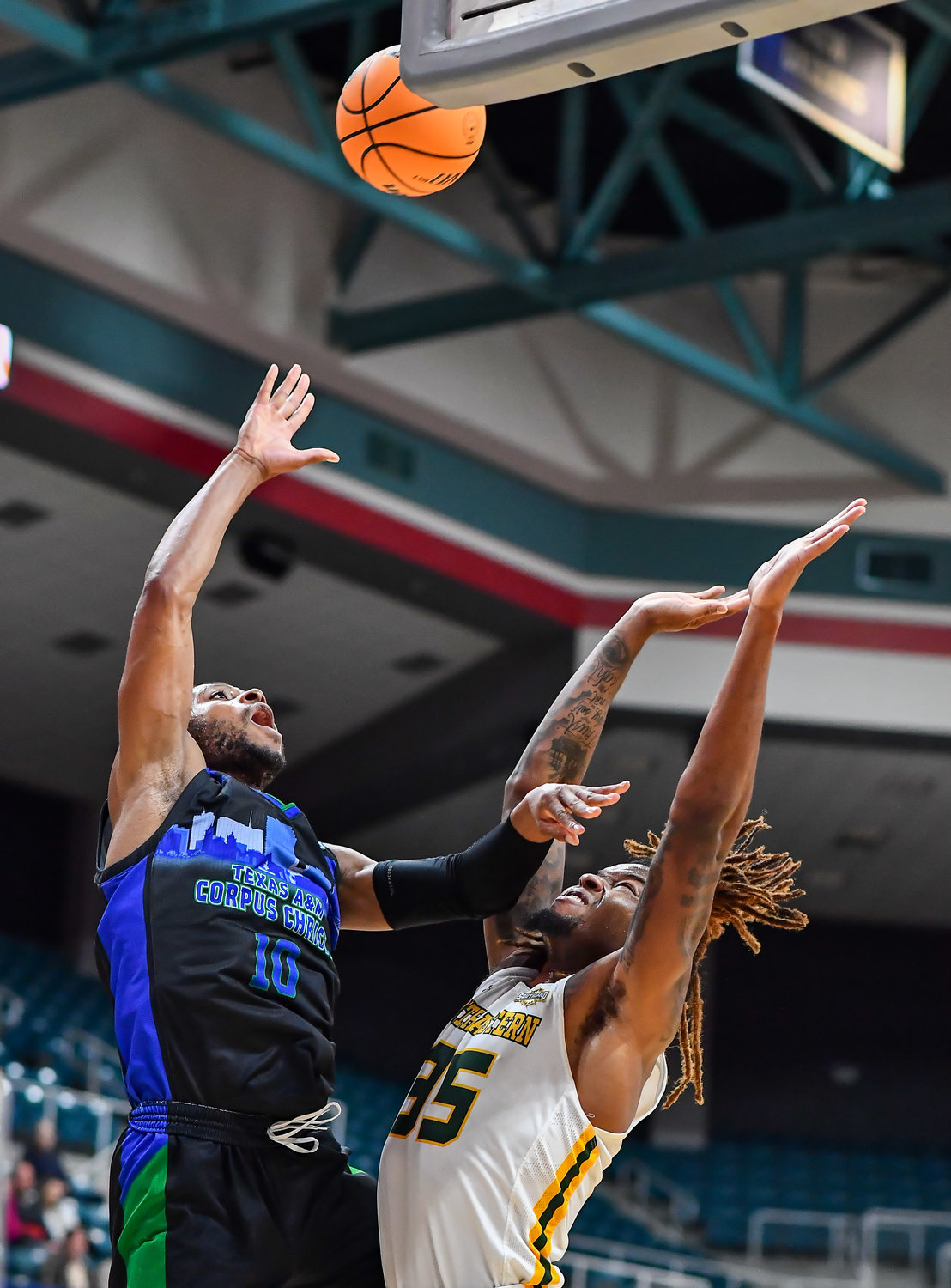 March 12,, 2022:  A&M-Corpus Christis Isaac Mushila #10 gets the shot off guarded by Southeastern Louisianas Gus Okafor #35 during the Southland Conference Basketball Championship game between A&M Corpus Christi vs Southeastern Louisiana. (Photo by Mark Goodman / Katy Times)