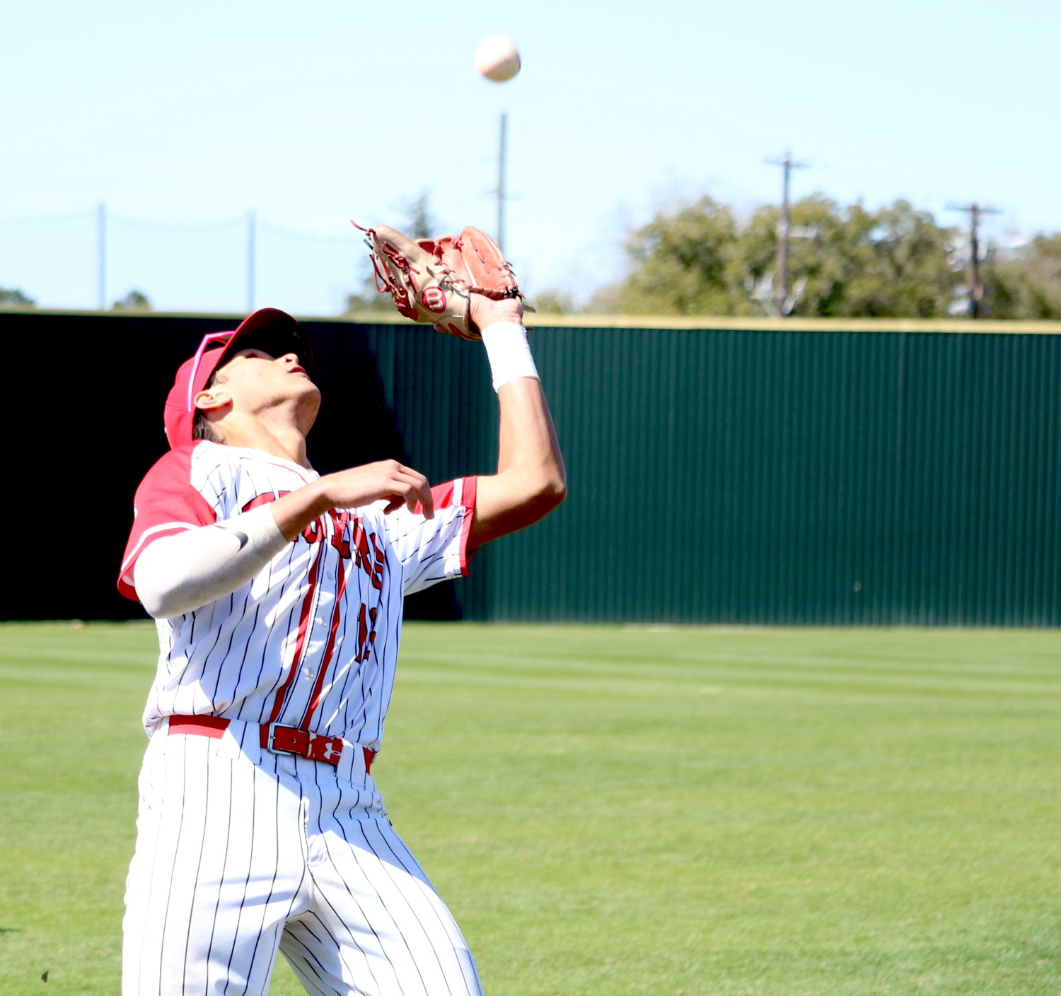 Nayden Ramirez catches a pop fly in foul territory during Friday’s game between Katy and Cinco Ranch at the Katy baseball field.