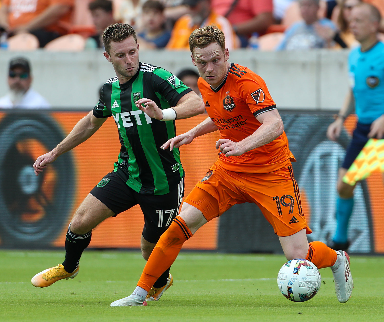 Houston Dynamo forward Tyler Pasher (19) works against Austin FC forward Jon Gallagher (17) during the first half of a Major League Soccer match between the Houston Dynamo and Austin FC on April 30, 2022 in Houston, Texas.