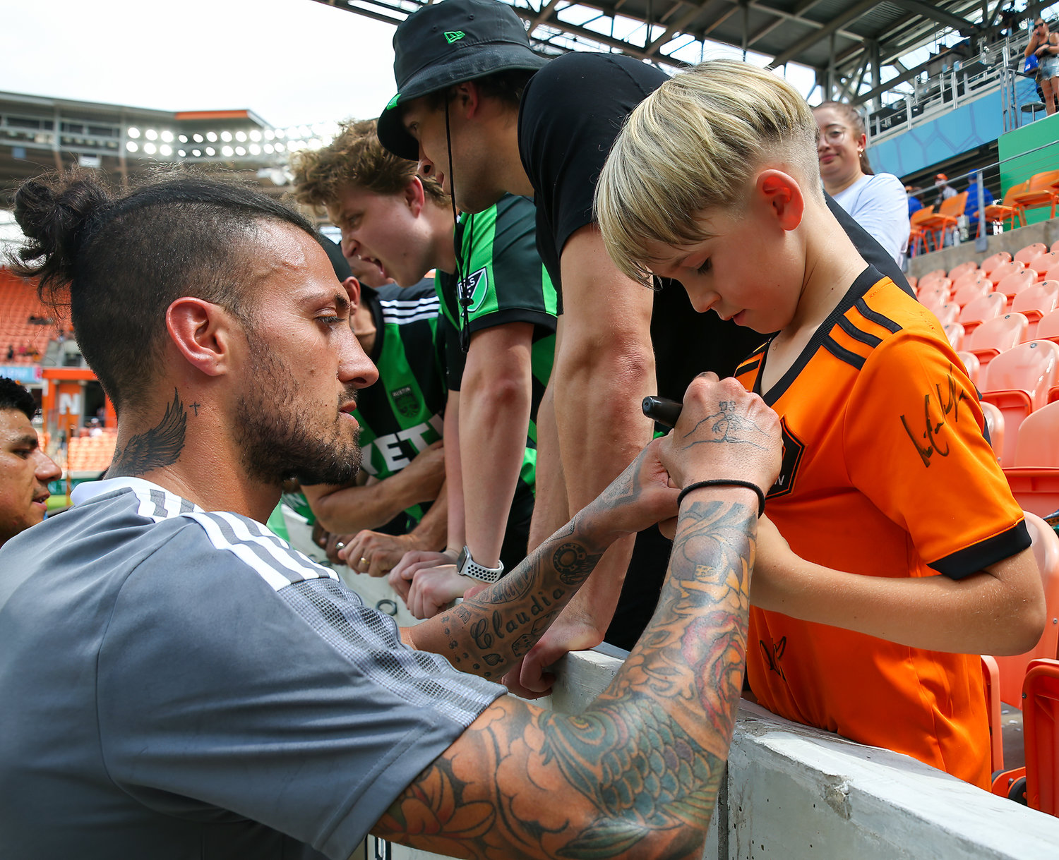 Austin FC forward Maximiliano Urruti (37), who played last year for the Houston Dynamo, signs a young Houston fan’s jersey after a Major League Soccer match on April 30, 2022 in Houston, Texas.