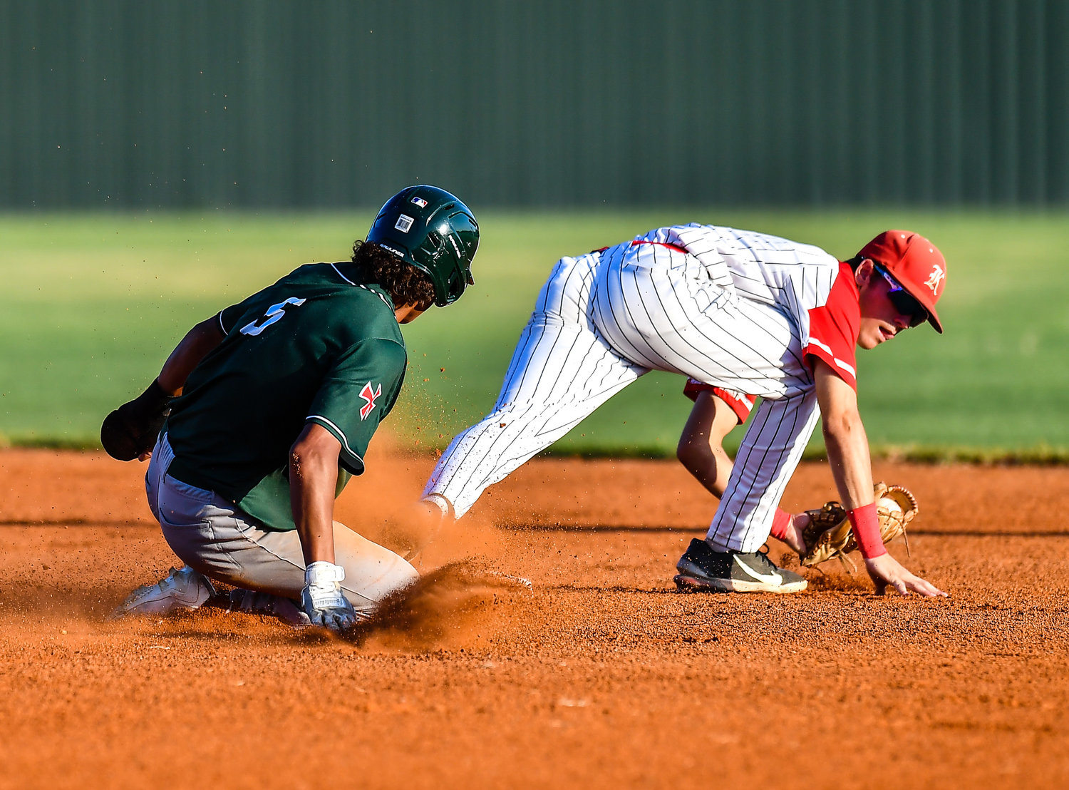 Strake Jesuits VERNON Clay (6) slides safely into as Katy's Graham Laxton (1) takes the throw from the out field during the first inning during a Region III-6A SemiFinals baseball game between Katy and Strake Jesuit at Mayde Creek High School, Friday, May 27, 2022.