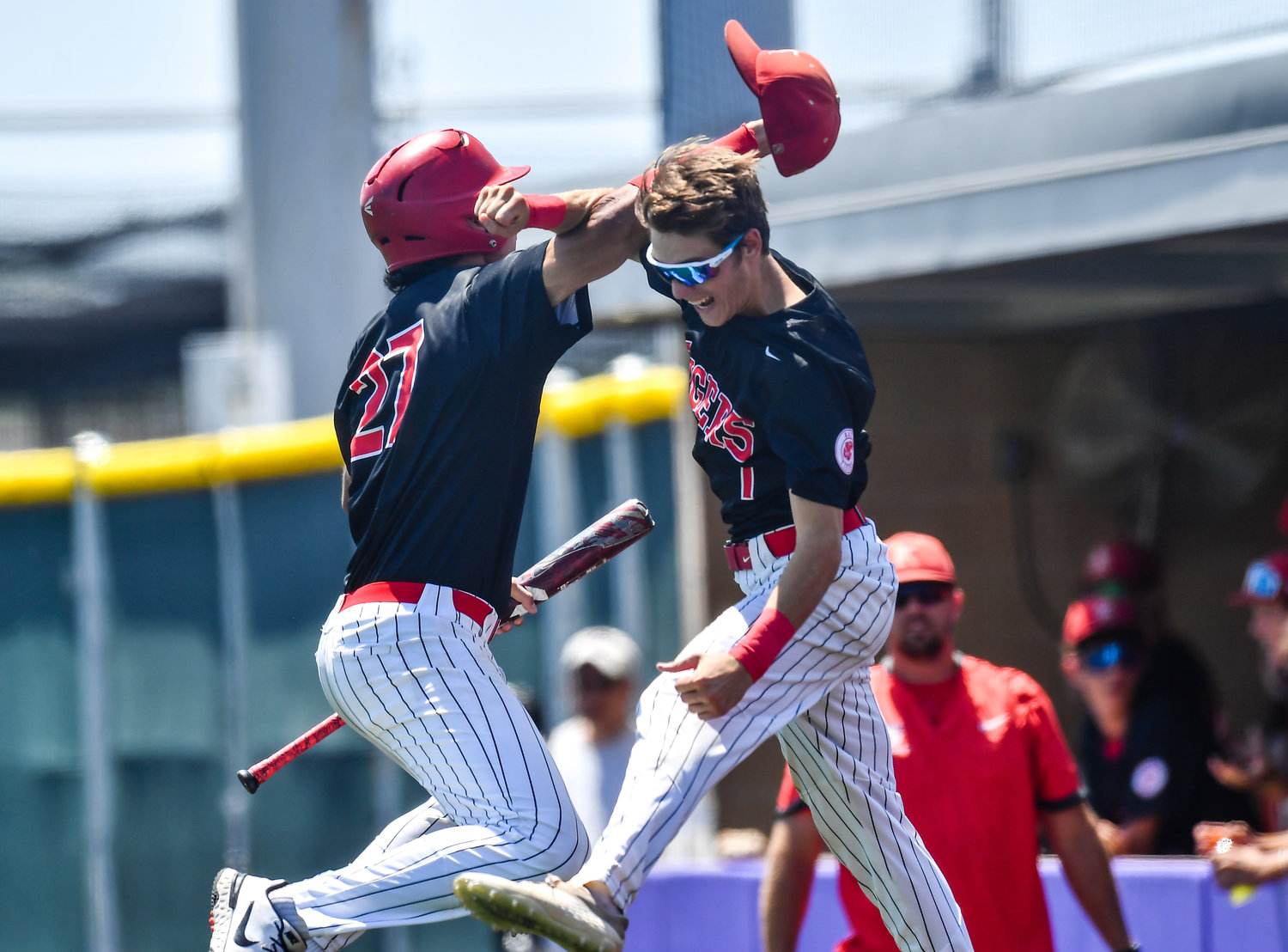 Katy's Jhonnatan Ferrebus (27) celebrates with Katy's Graham Laxton (1) after scoring for the Tigers during the sixth inning of game three during a Region III-6A Regional SemiFinals baseball game between Katy and Strake Jesuit at Jersey Village High School, Saturday, May 28, 2022.