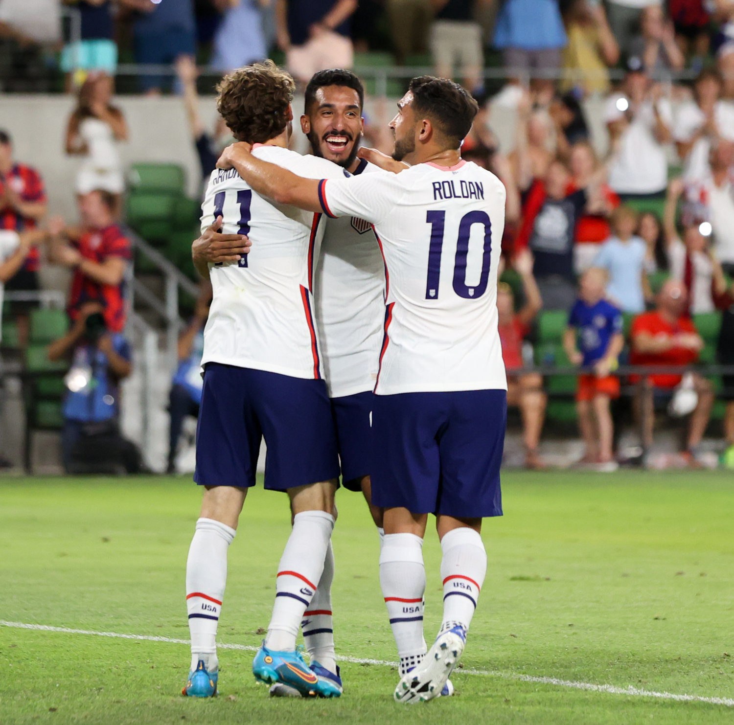United States forward Brendan Aaronson (11) and forward Christian Pulisic (10) congratulate forward Jesus Ferriera  (center) after a goal during a Concacaf Nations League match on June 10, 2022 in Austin, Texas. Ferriera scored four of the USA’s five goals in the 5-0 win over Grenada.