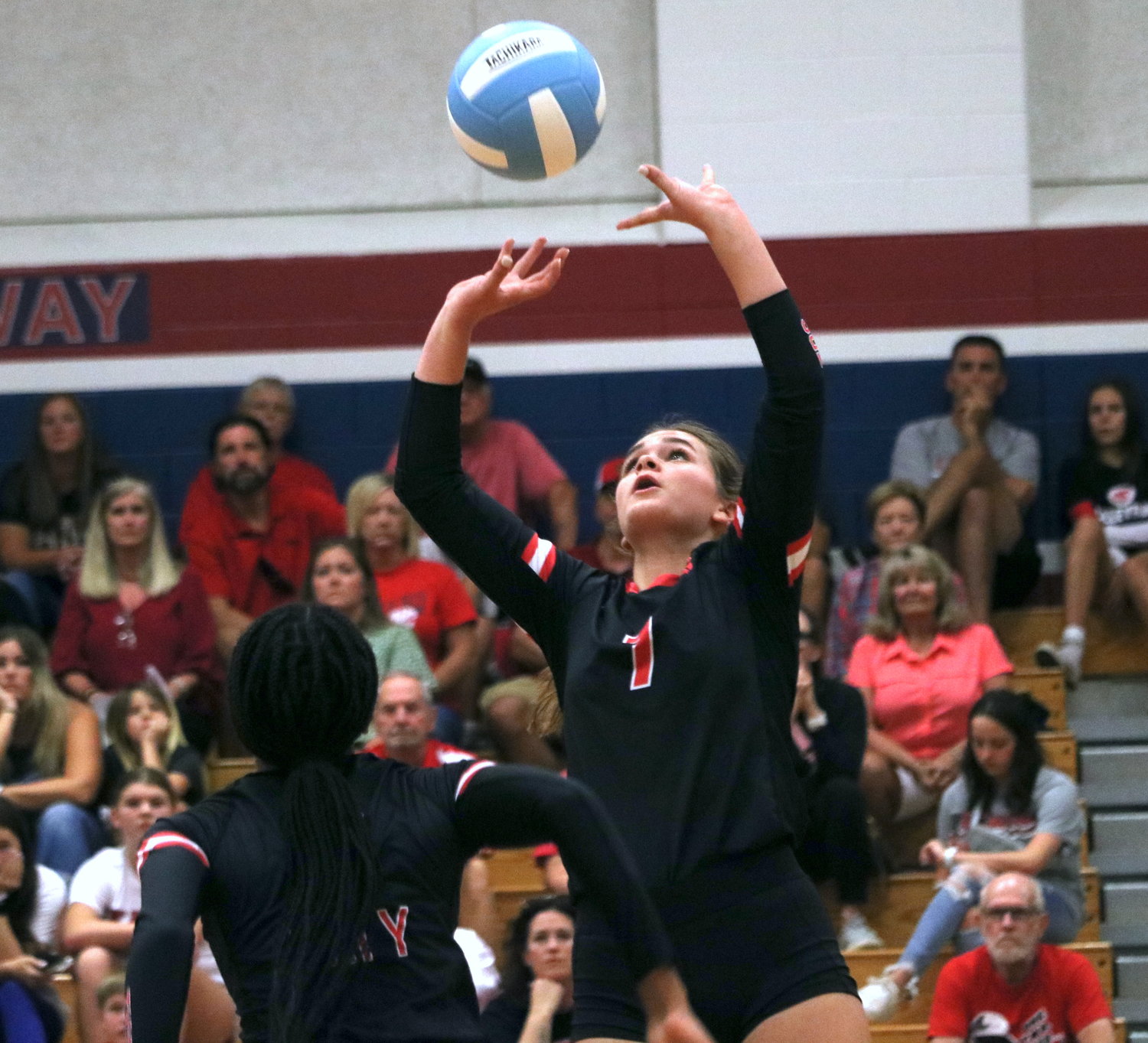 Katy’s Gabi Young sets a ball during Tuesday’s match between Tompkins and Katy at the Tompkins gym.
