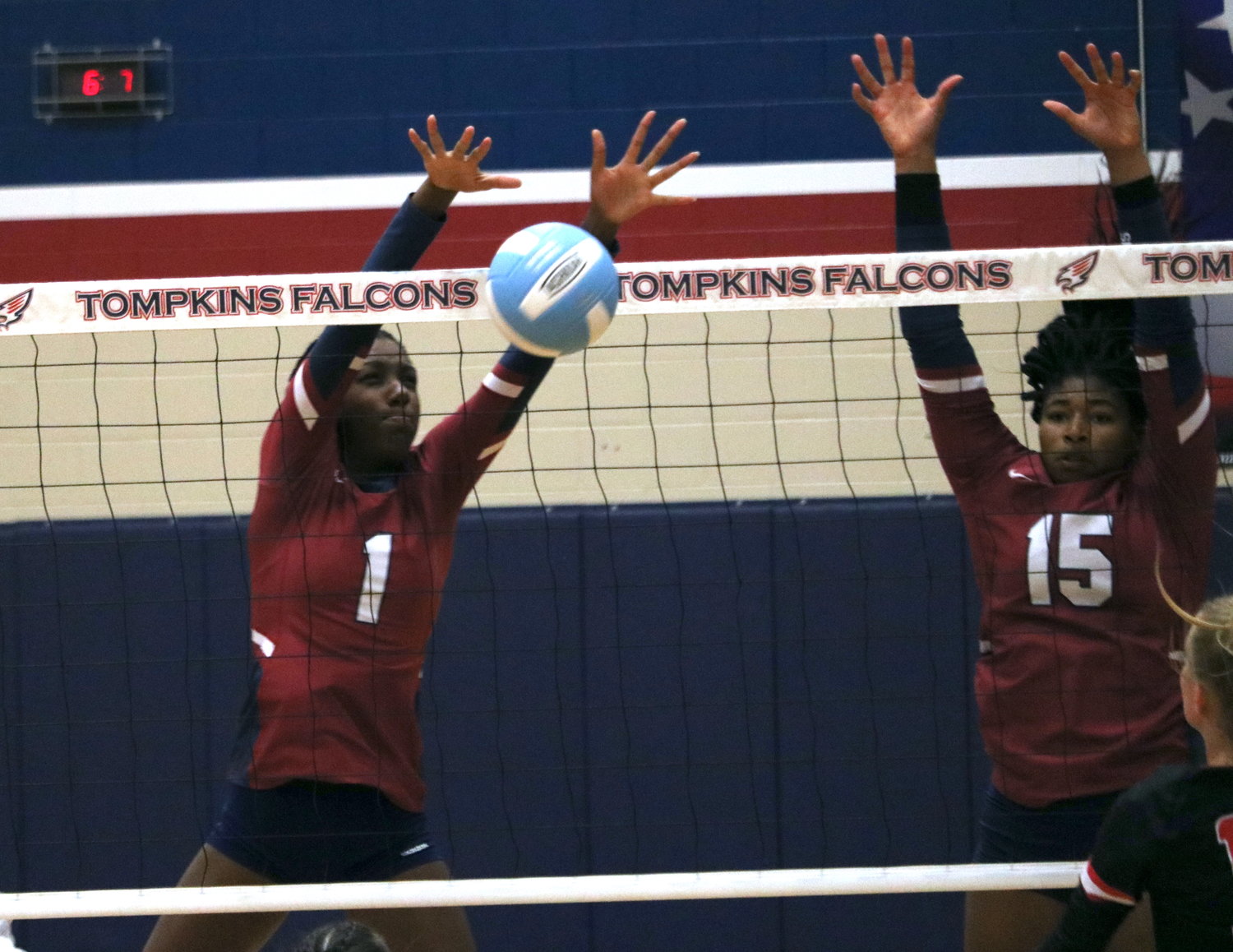 Tompkins’ Christin Cowart and Tendai Titley block a kill attempt during Tuesday’s match between Tompkins and Katy at the Tompkins gym.
