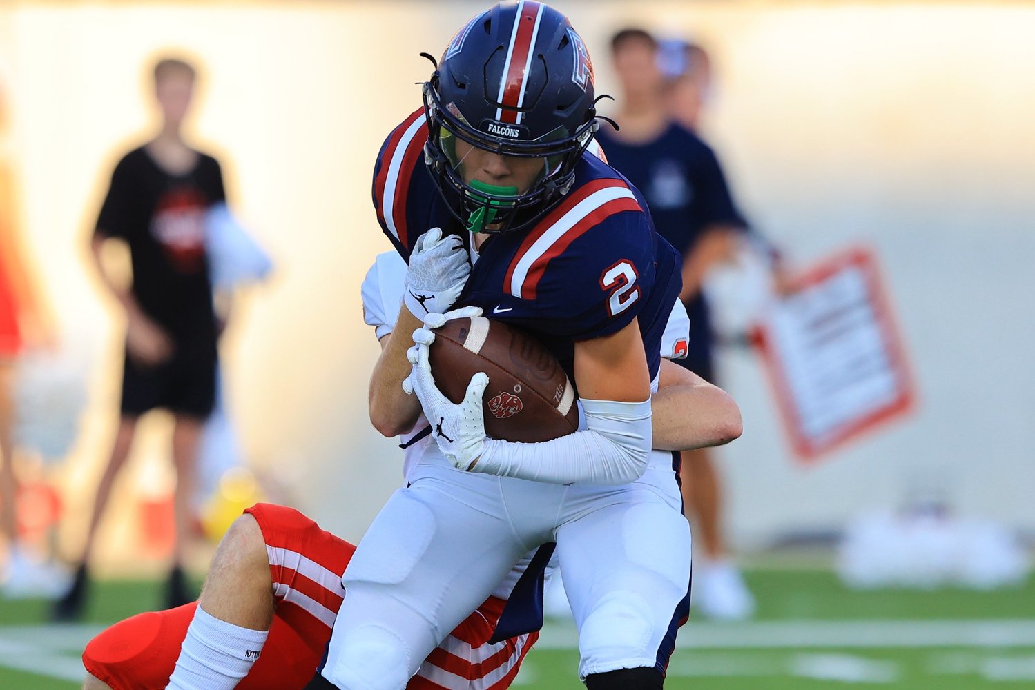 Tompkins Cody Chapman fights for yardage after intercepting a pass during Saturday’s game between Katy and Tompkins at Legacy Stadium.