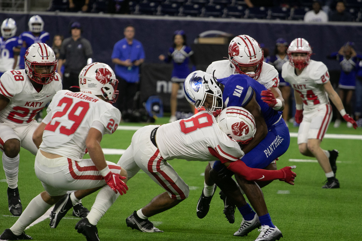 Katy players tackle a C.E. King player during Friday's Class 6A-Division II Region III Final between Katy and C.E. King at NRG Stadium.