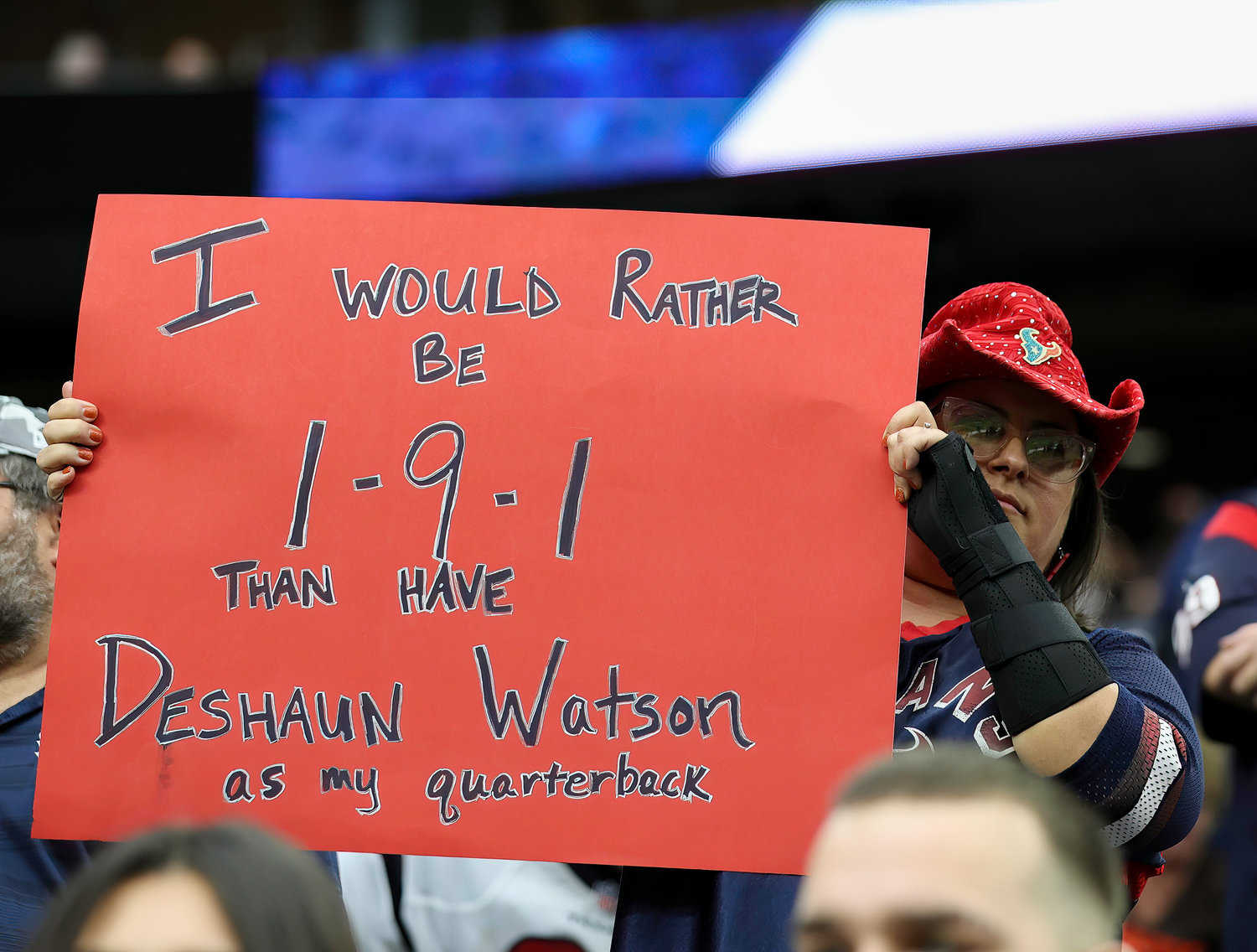 A Houston Texans fan holds up a sign about former Texans and current Cleveland Browns quarterback Deshaun Watson during an NFL game between the Texans and the Browns on Dec. 4, 2022, in Houston. The Browns won, 27-14.