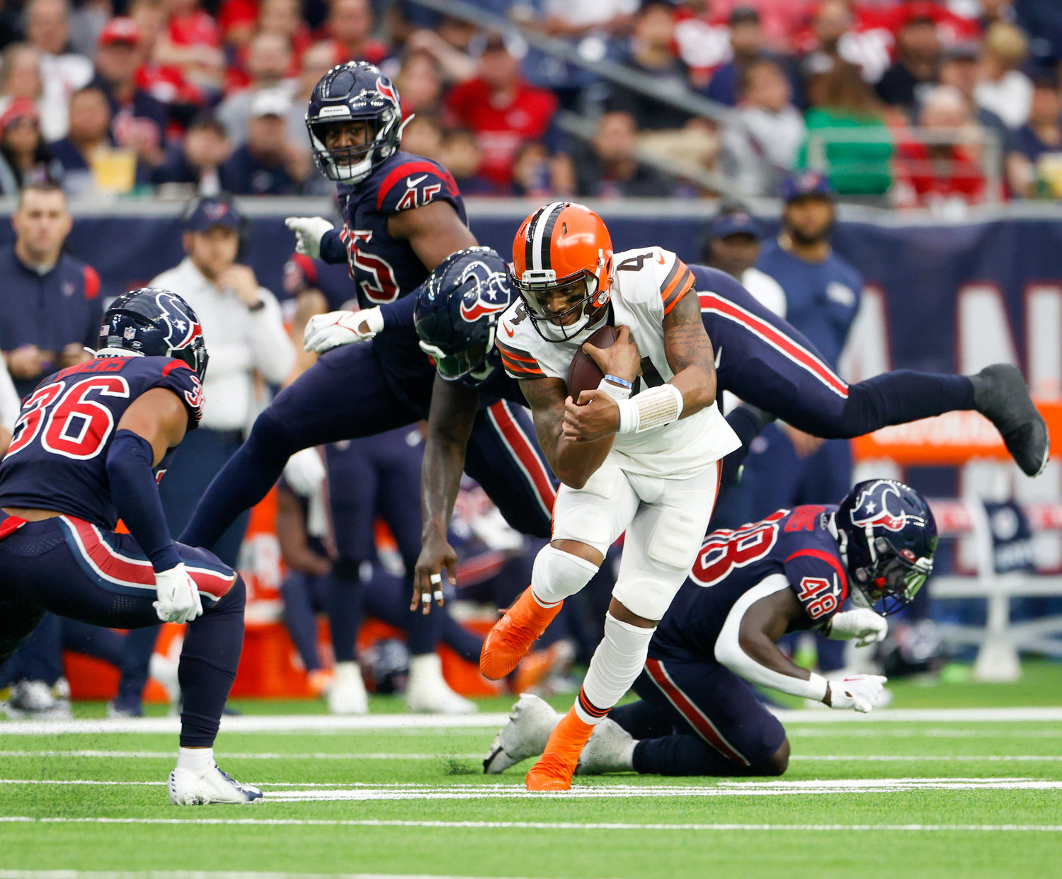 Cleveland Browns quarterback Deshaun Watson (4) avoids defenders while carrying the ball during an NFL game between the Houston Texans and the Cleveland Browns on Dec. 4, 2022, in Houston. The Browns won, 27-14.