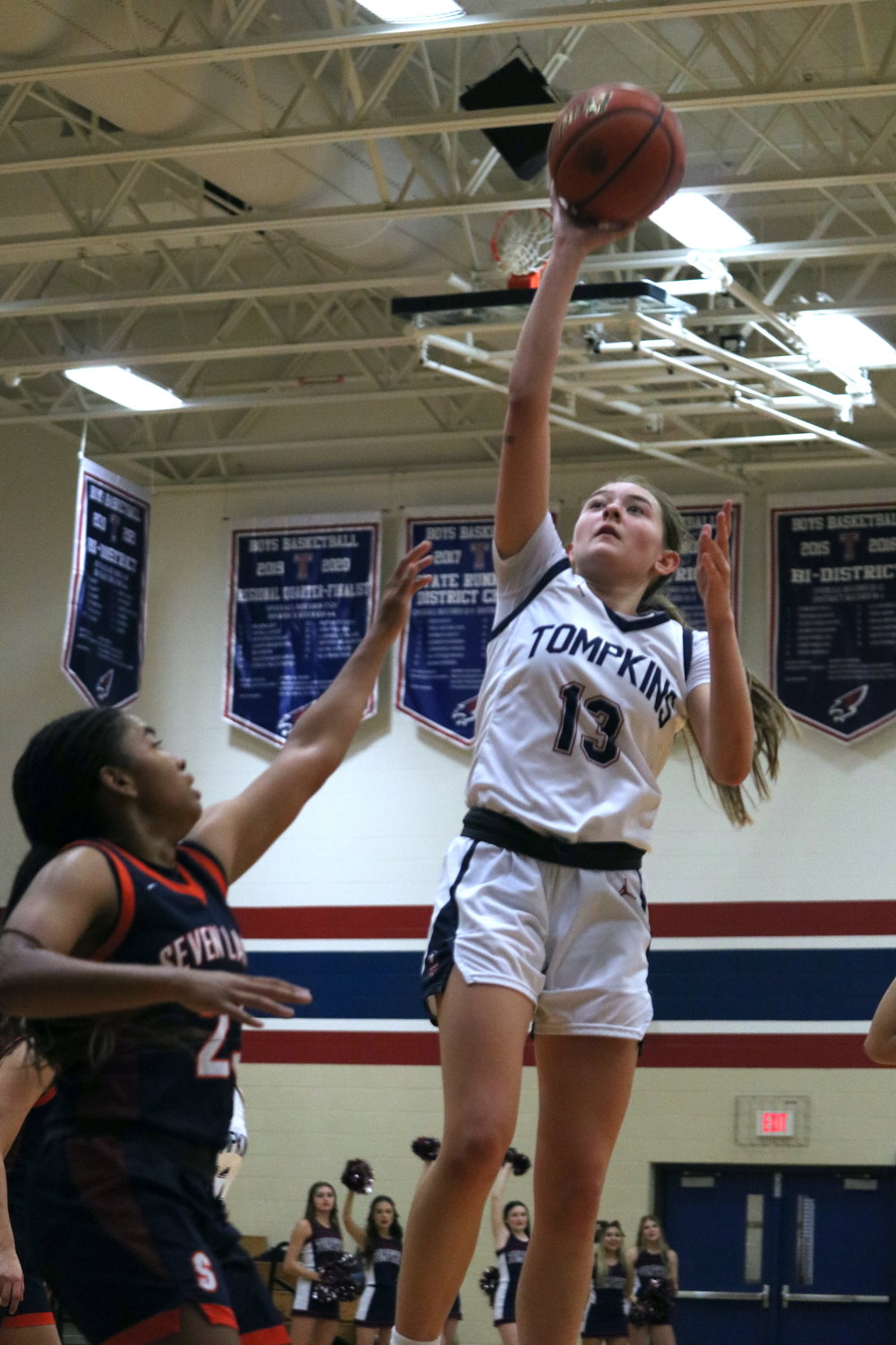 Macy Spencer shoots a floater during Tuesday’s District 19-6A game between Tompkins and Seven Lakes at the Tompkins gym.