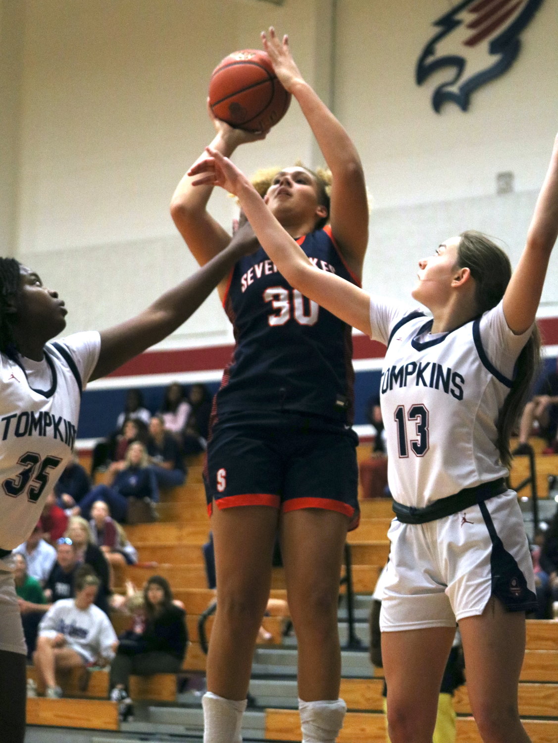 Justice Carlton shoots a jumper during Tuesday’s District 19-6A game between Tompkins and Seven Lakes at the Tompkins gym.
