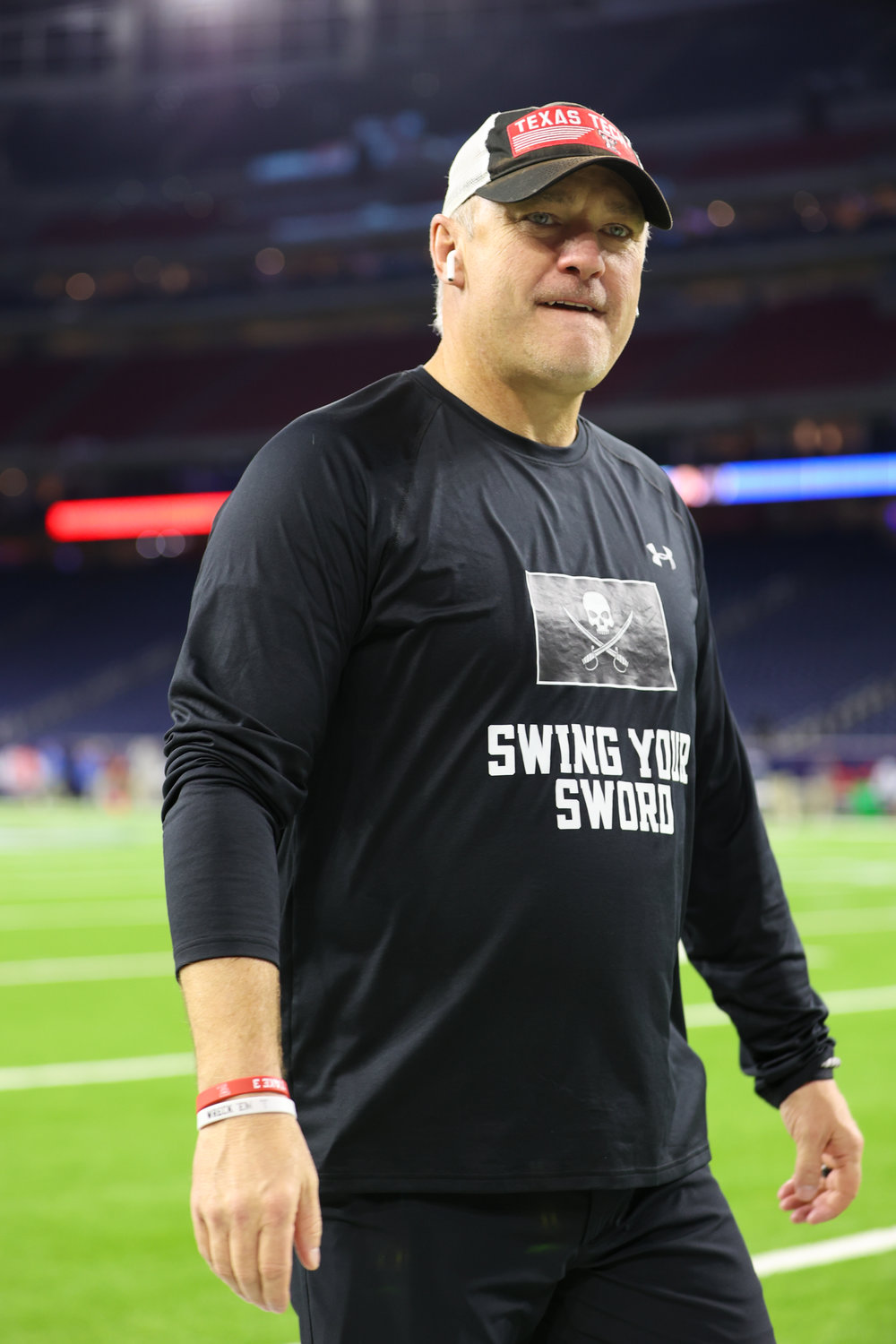 Texas Tech head coach Joey McGuire wears a “Swing Your Sword” shirt on the field prior to the start of the TaxAct Texas Bowl on Dec. 28, 2022 in Houston. The shirt is in honor of former Texas Tech head coach Mike Leach, who passed away on Dec. 12.