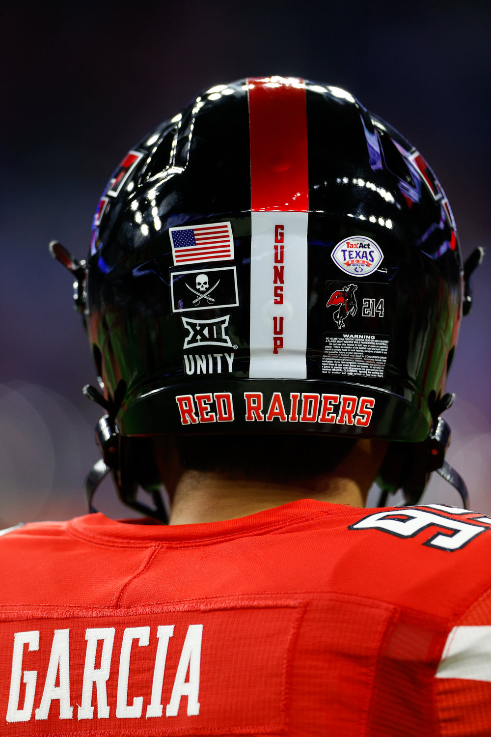 Texas Tech place kicker Gino Garcia (99) warms up on the field prior to the start of the TaxAct Texas Bowl on Dec. 28, 2022 in Houston. The Red Raiders’ helmets include a pirate flag in honor of former Texas Tech head coach Mike Leach, who passed away on Dec. 12.