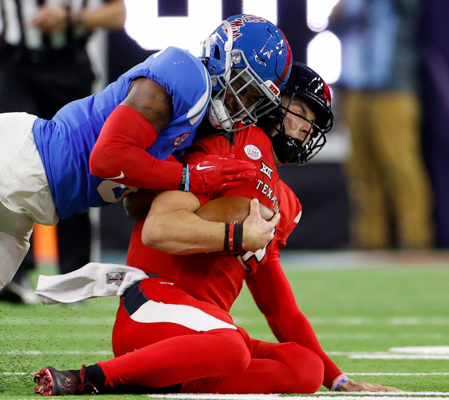 Mississippi linebacker Troy Brown (8) is flagged for targeting on a helmet-to-helmet hit on a sliding Texas Tech quarterback Tyler Shough (12) during the TaxAct Texas Bowl on Dec. 28, 2022 in Houston.
