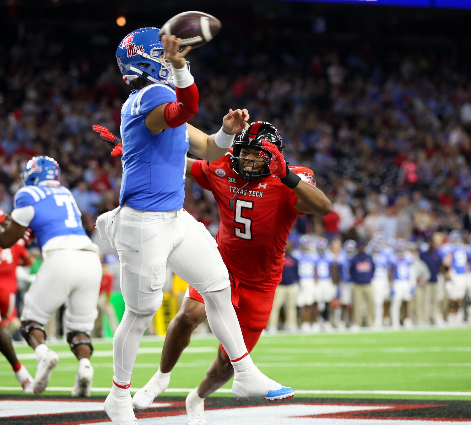Texas Tech defensive lineman Myles Cole (5) presses Mississippi quarterback Jaxson Dart (2) in the end zone during the TaxAct Texas Bowl on Dec. 28, 2022 in Houston.