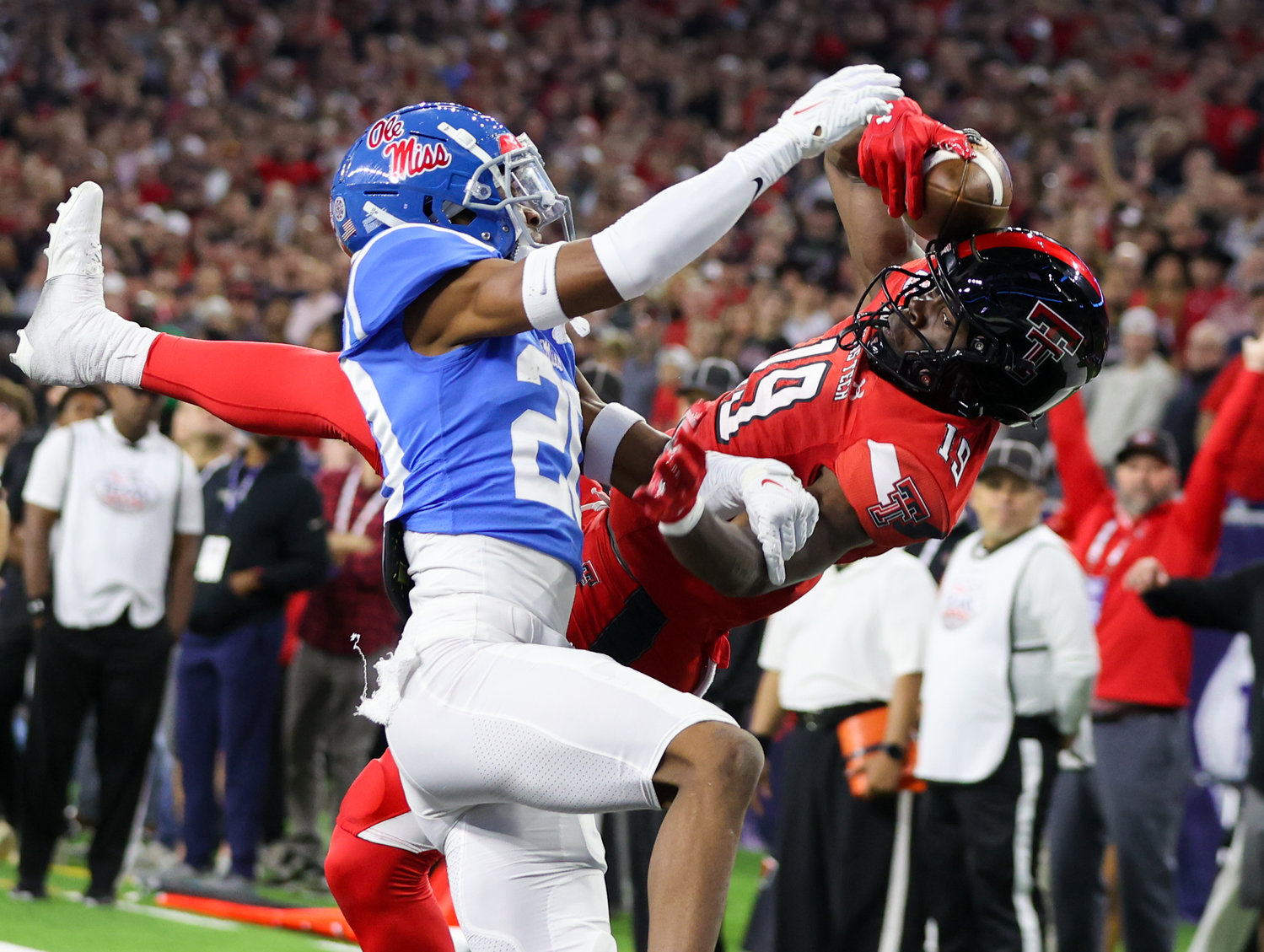 Mississippi cornerback Davison Igbinosun (20) dislodges a would-be touchdown pass intended for Mississippi wide receiver Dayton Wade (19) during the TaxAct Texas Bowl on Dec. 28, 2022 in Houston.