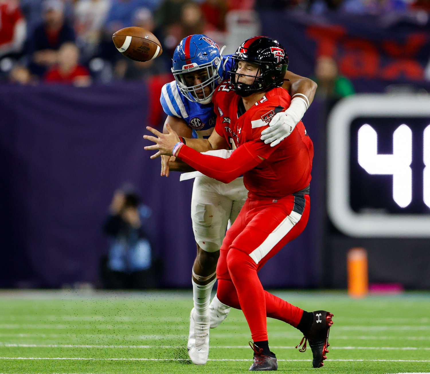 Mississippi defensive end Tavius Robinson (95) forces a fumble on a sack of Texas Tech quarterback Tyler Shough (12) during the TaxAct Texas Bowl on Dec. 28, 2022 in Houston.