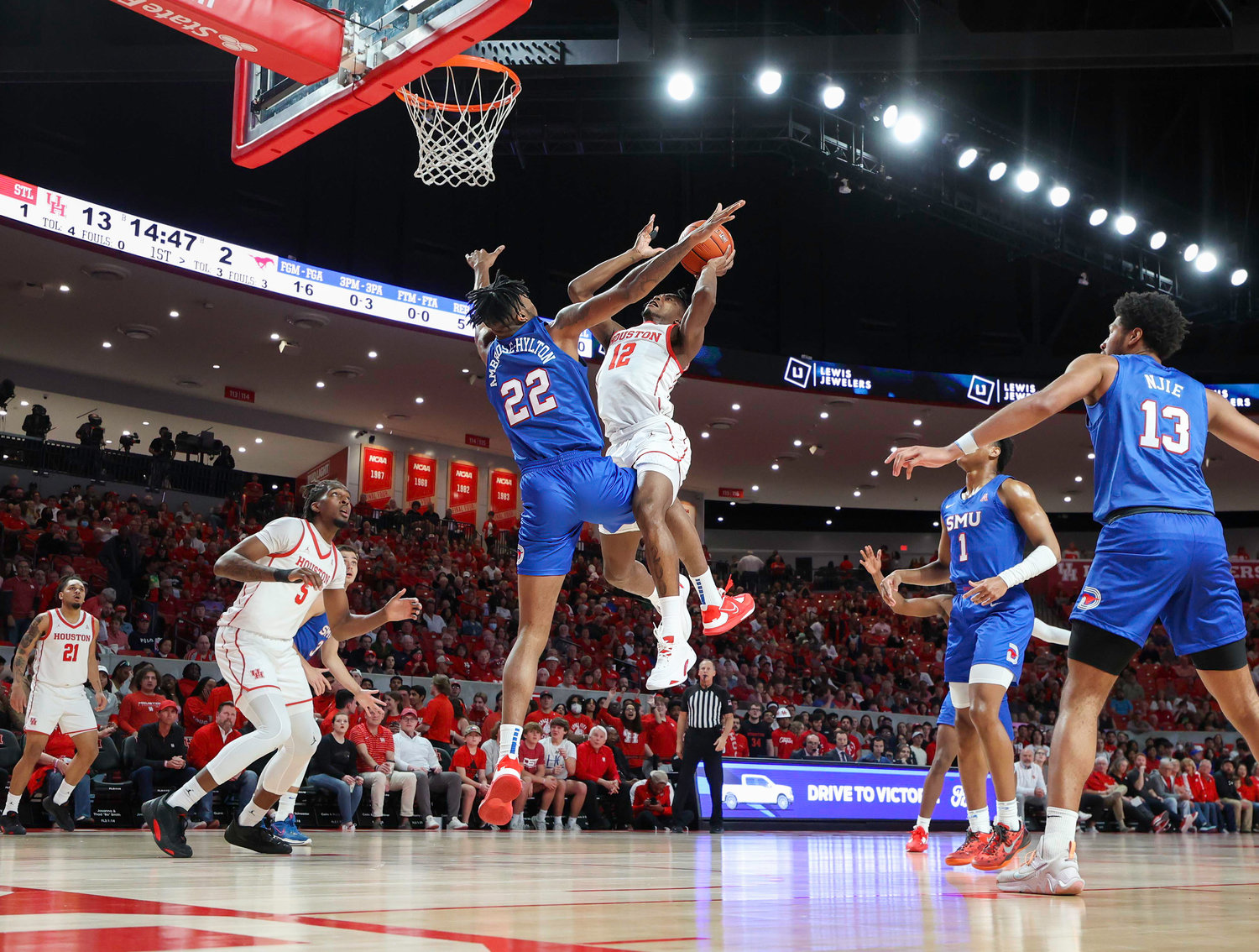 Houston guard Tramon Mark (12) goes to the basket against SMU forward Keon Ambrose-Hylton (22) during an NCAA men’s basketball game between the Houston Cougars and the Southern Methodist Mustangs on Jan. 5, 2023 in Houston. Houston won, 87-53,