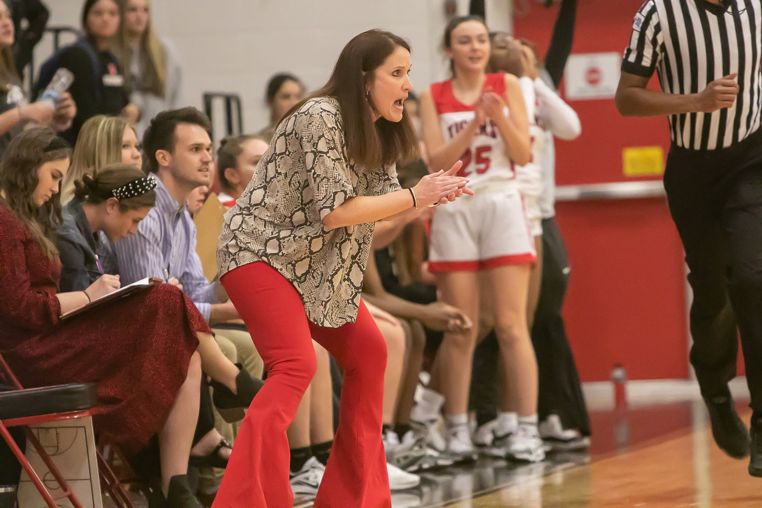 Katy head coach Shanna Marhofer speaks to her team from the sideline during Tuesday's game between Katy and Tompkins at the Katy gym.